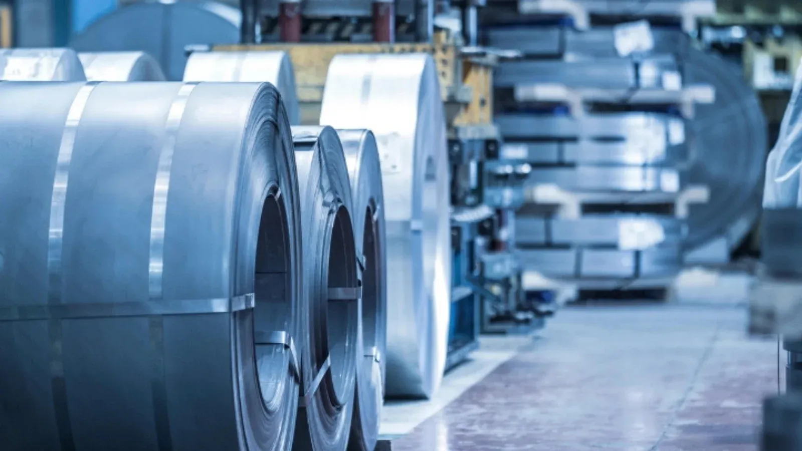 Close-up of coiled metal sheets in an industrial factory. Precision engineering materials.