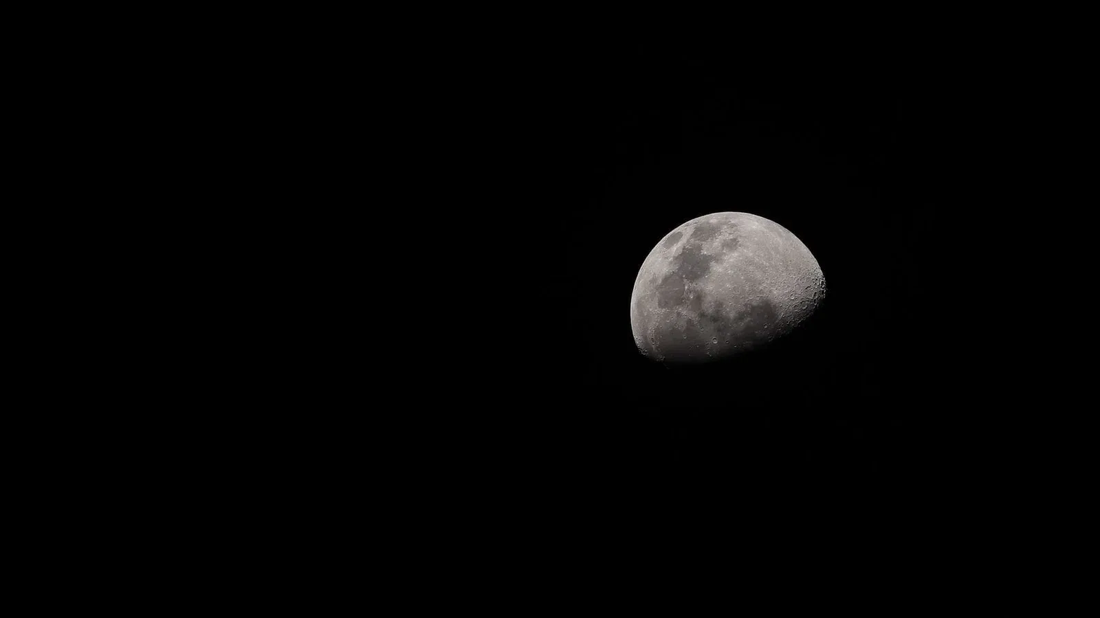 A crescent moon captured in detail against a dark night sky.