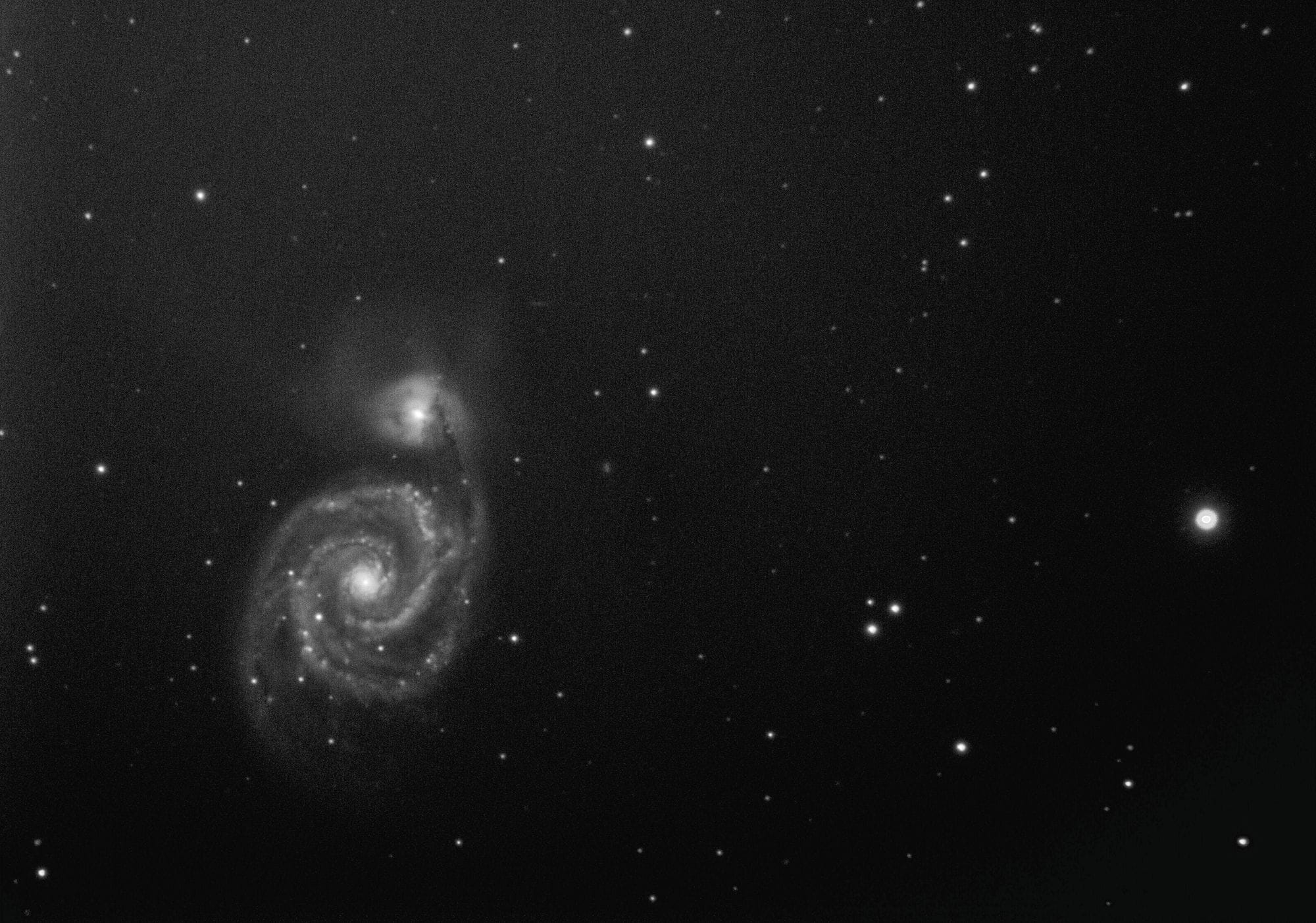 A captivating black and white image of a spiral galaxy in the expansive cosmos.