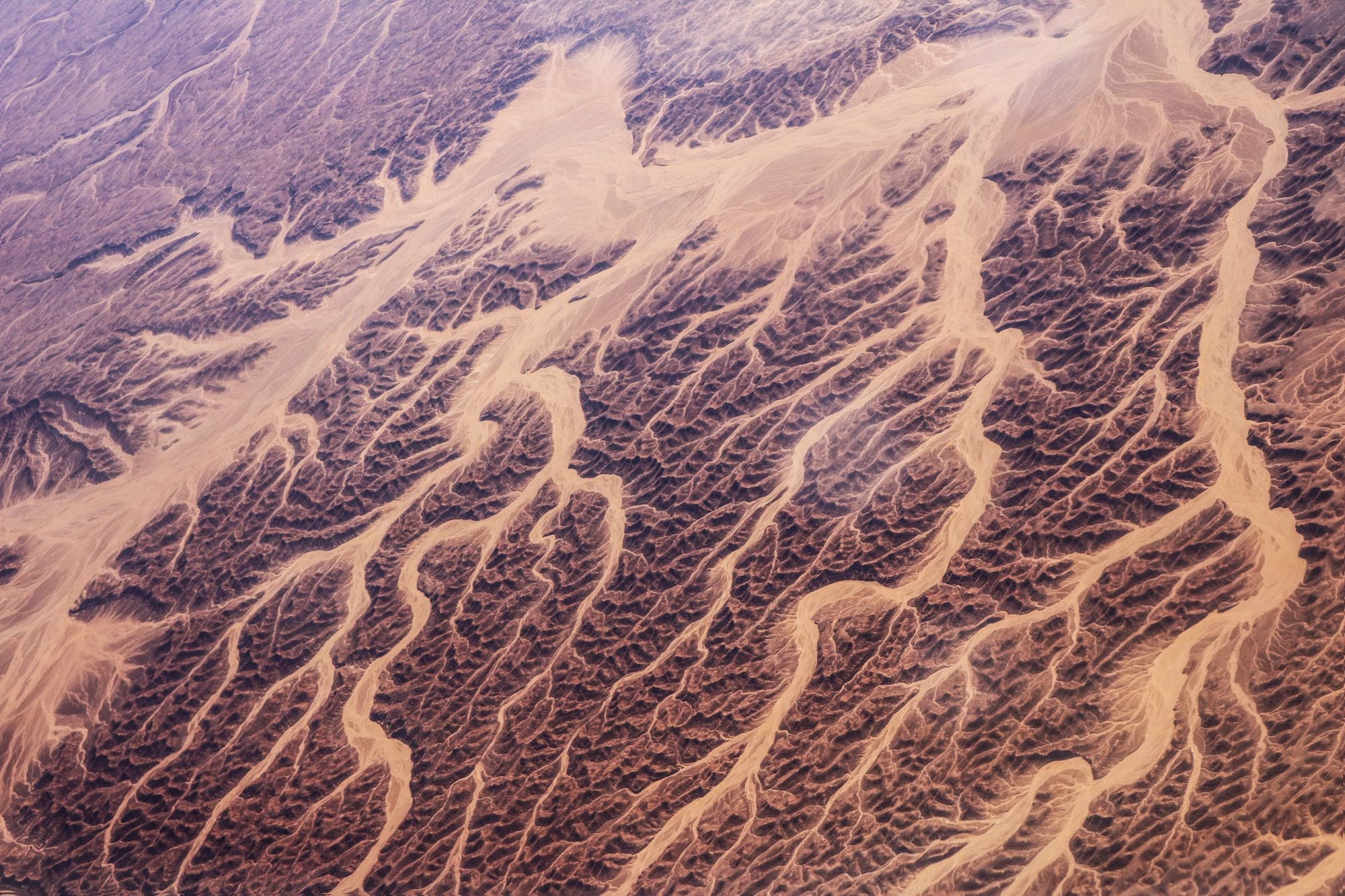 A breathtaking aerial view showcasing the intricate desert dunes and textures of Egypt's arid landscape.