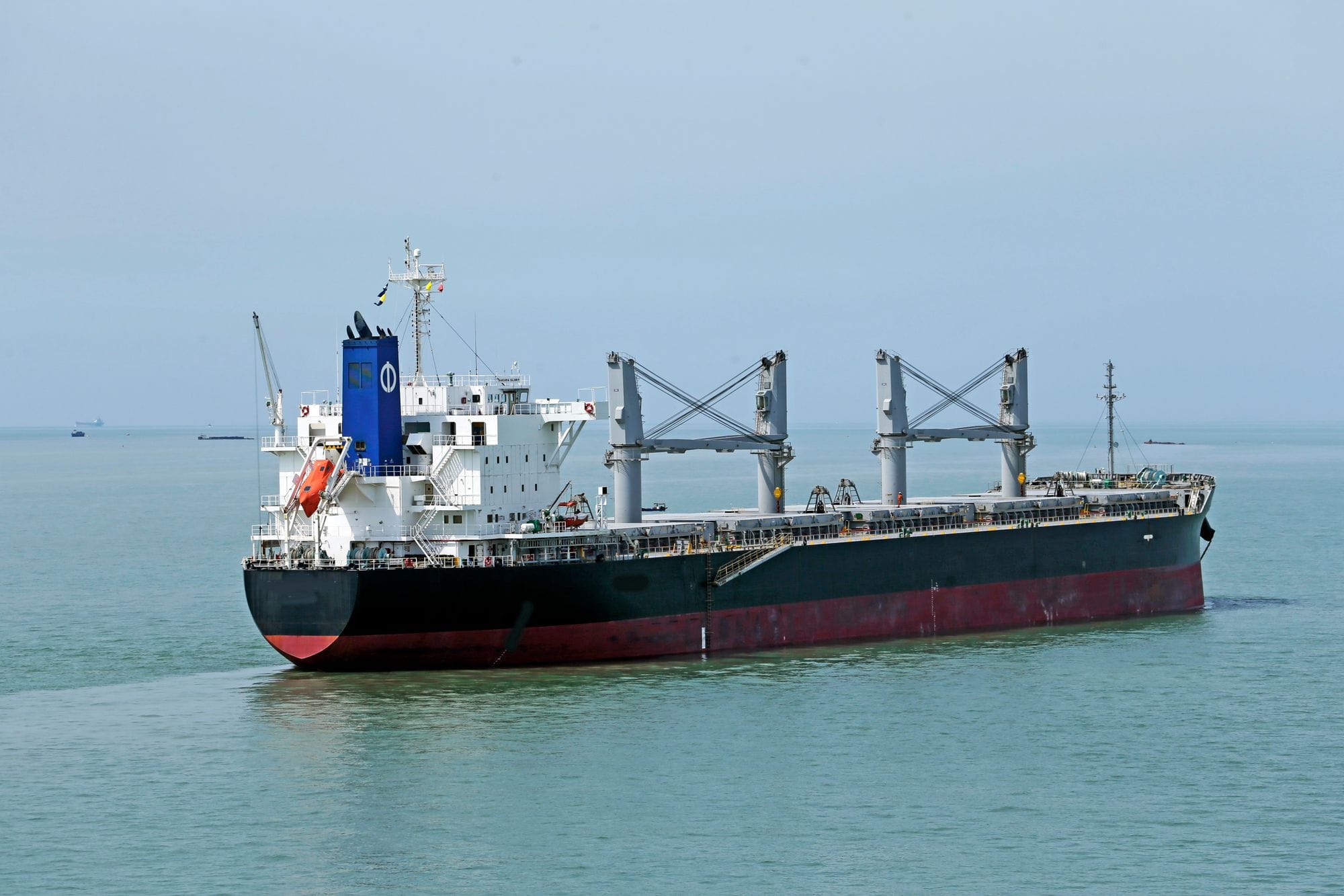 Cargo vessel navigating the calm waters of the open sea.