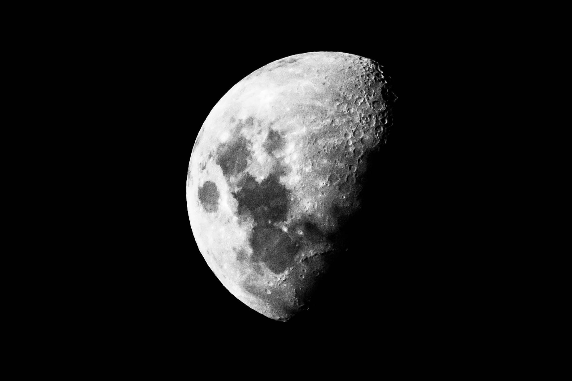 Close-up of the moon in monochrome, showcasing lunar surface details.