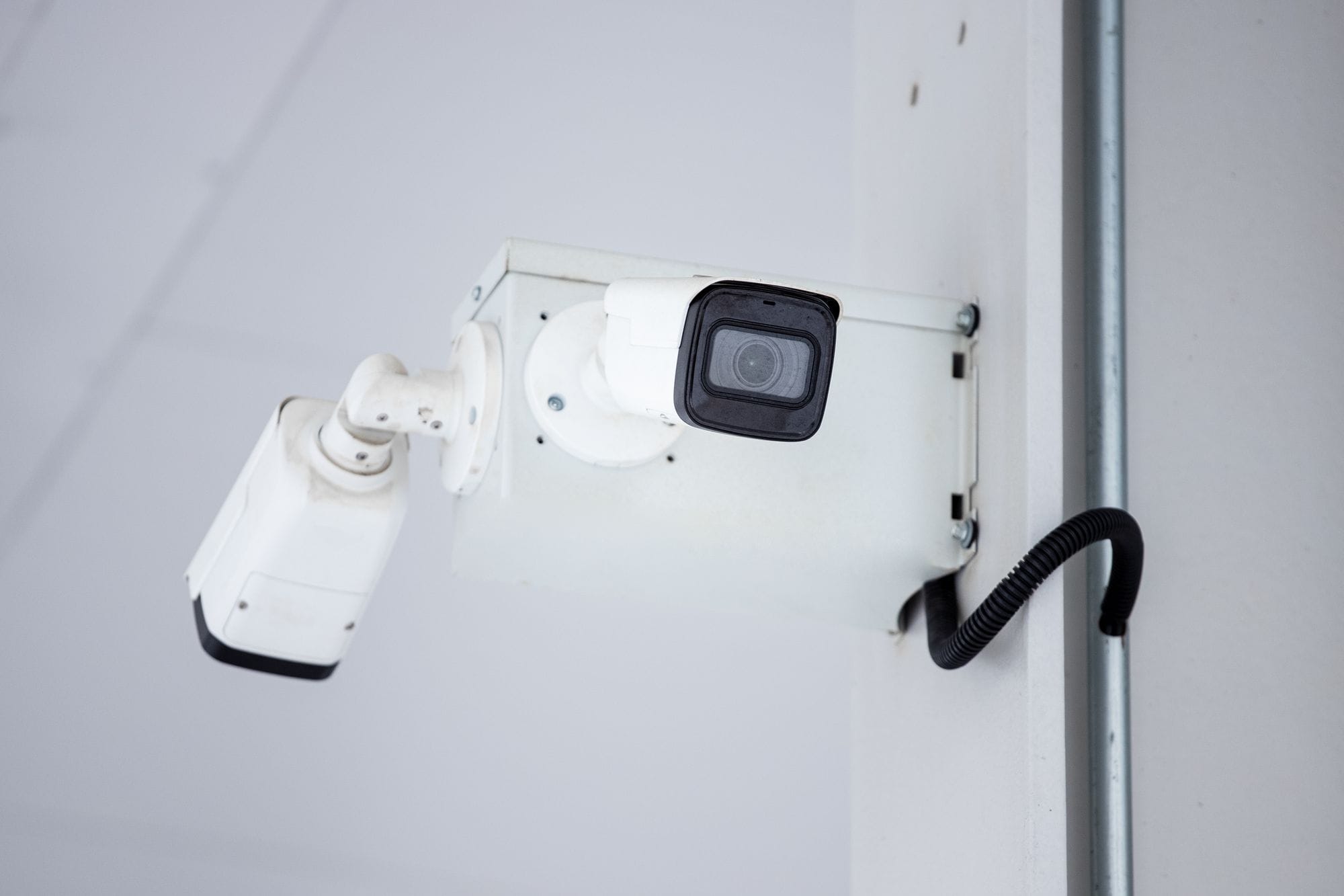 A close-up shot of a modern, mounted surveillance camera highlighting security and surveillance.
