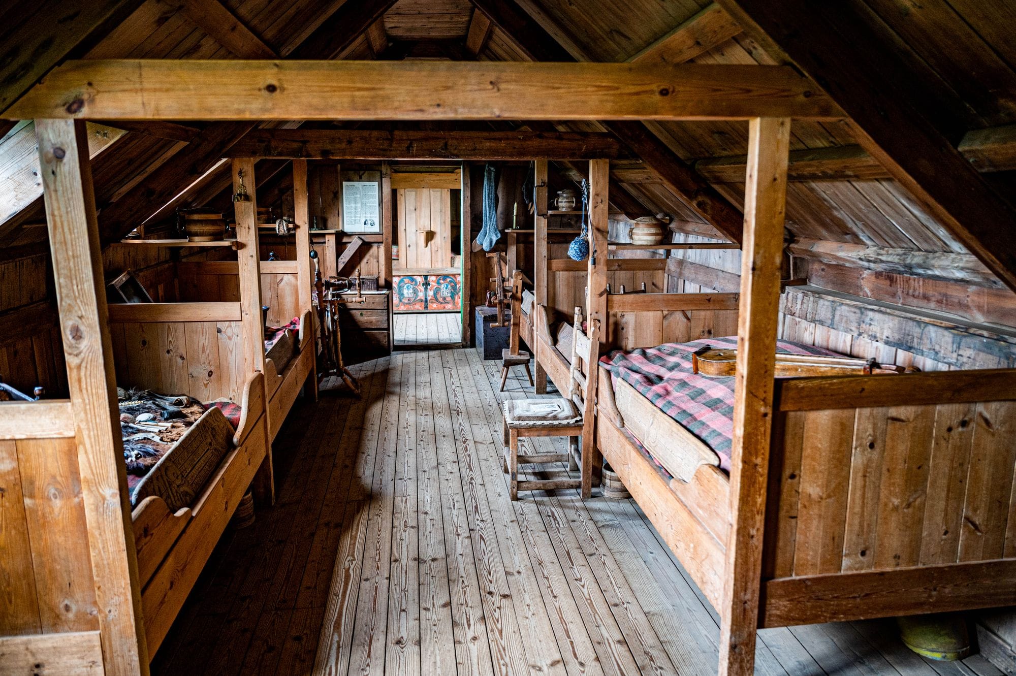 Cozy rustic attic bedroom with wooden furniture and cozy decor.