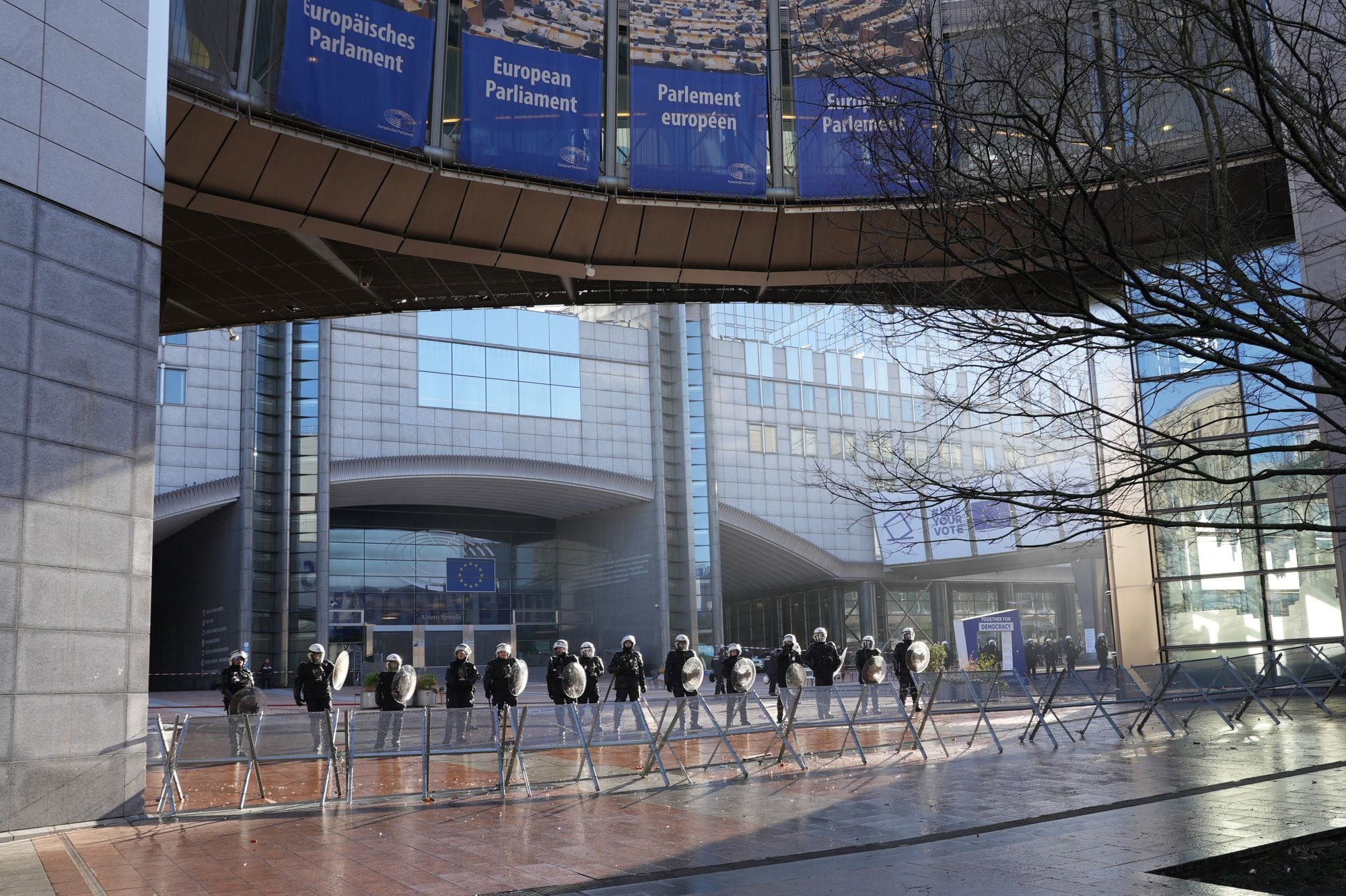 Police officers stand guard outside the European Parliament building in Brussels, Belgium.
