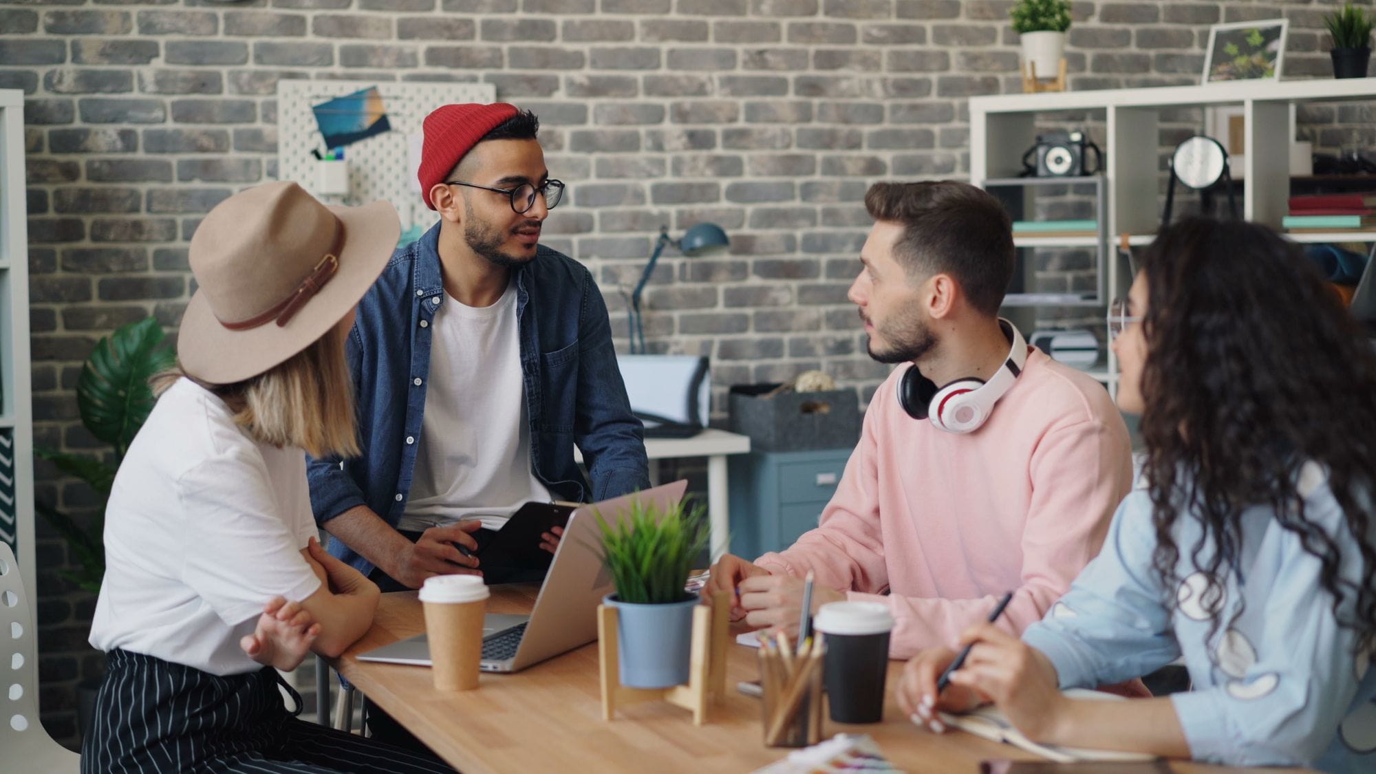 Young creative team discussing project ideas in a modern office setting.