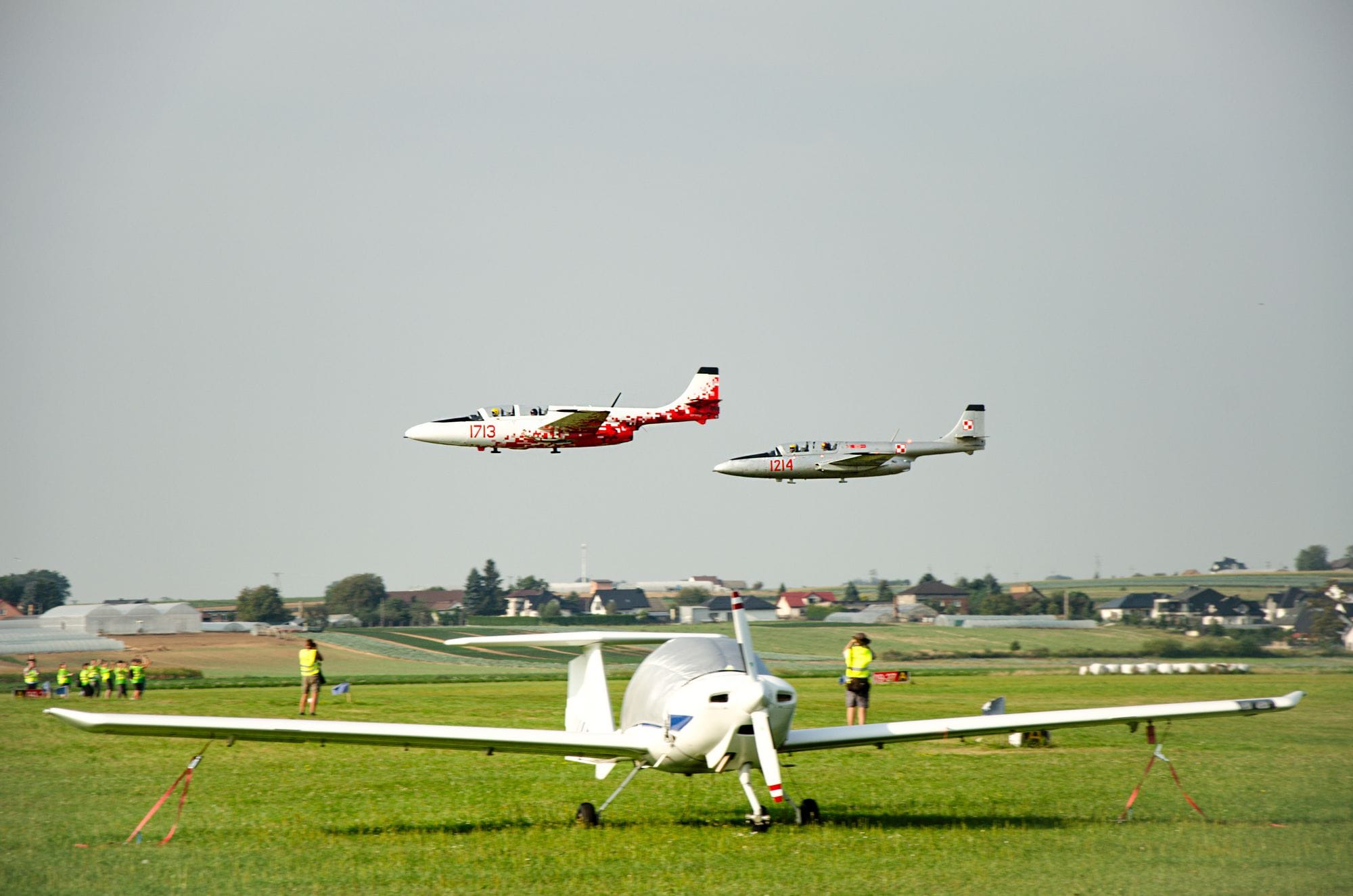 Multiple aircraft on a runway under clear skies, showcasing aviation and travel.