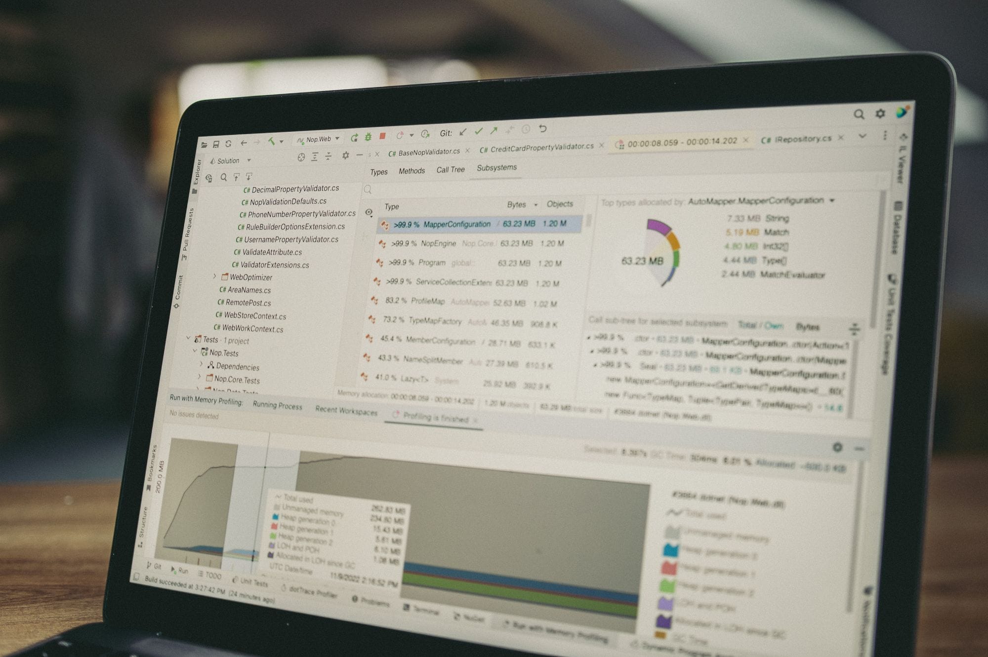 A close-up view of a laptop screen showing a coding and data analysis software interface in an indoor setting.