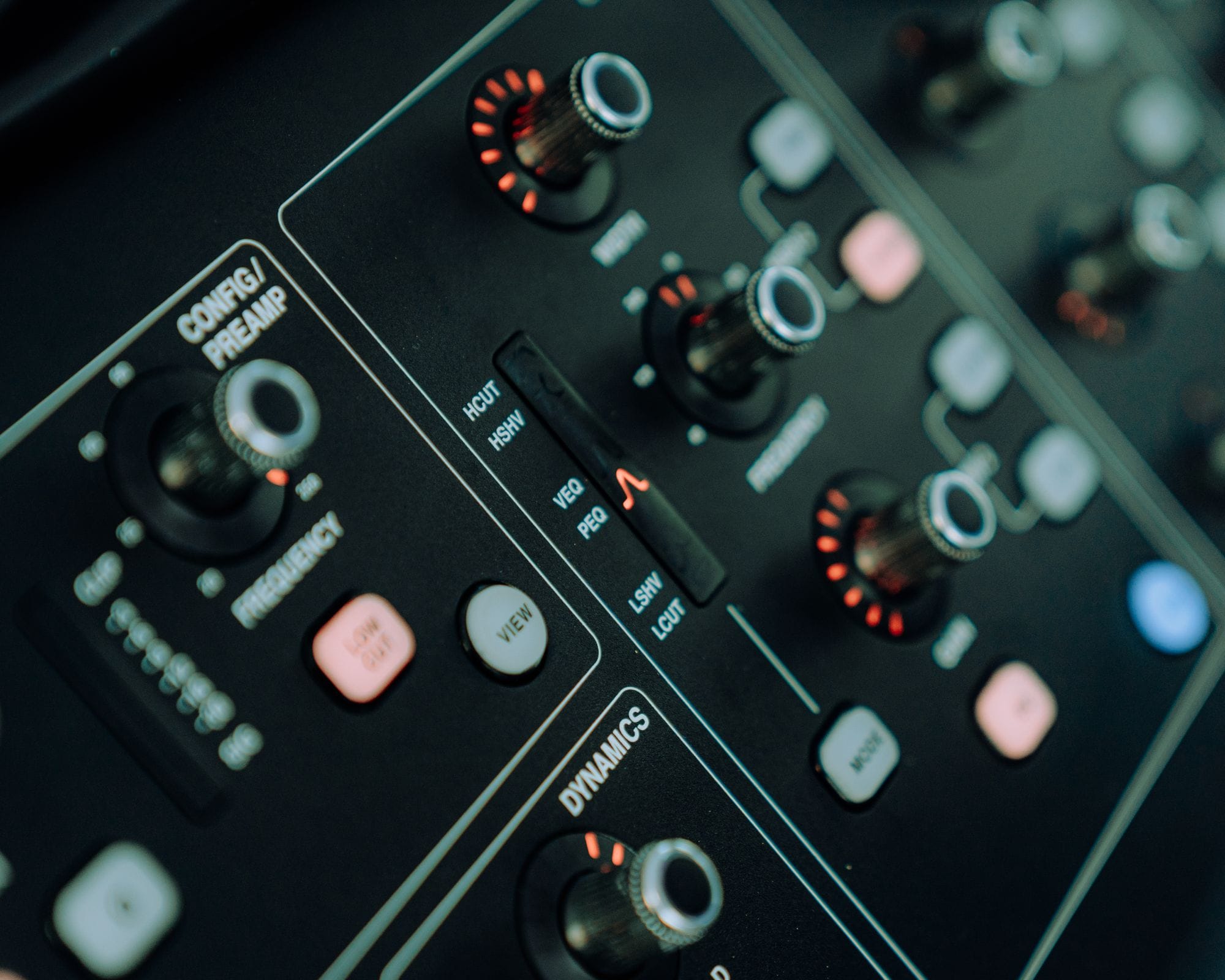 Detailed view of control knobs on a professional audio mixing console.
