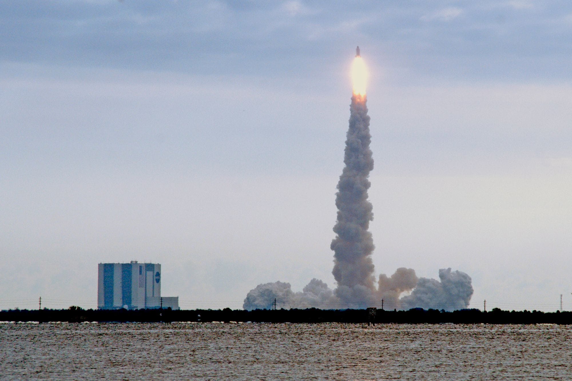Dramatic view of a rocket launching from Kennedy Space Center in Florida with a trail of smoke.