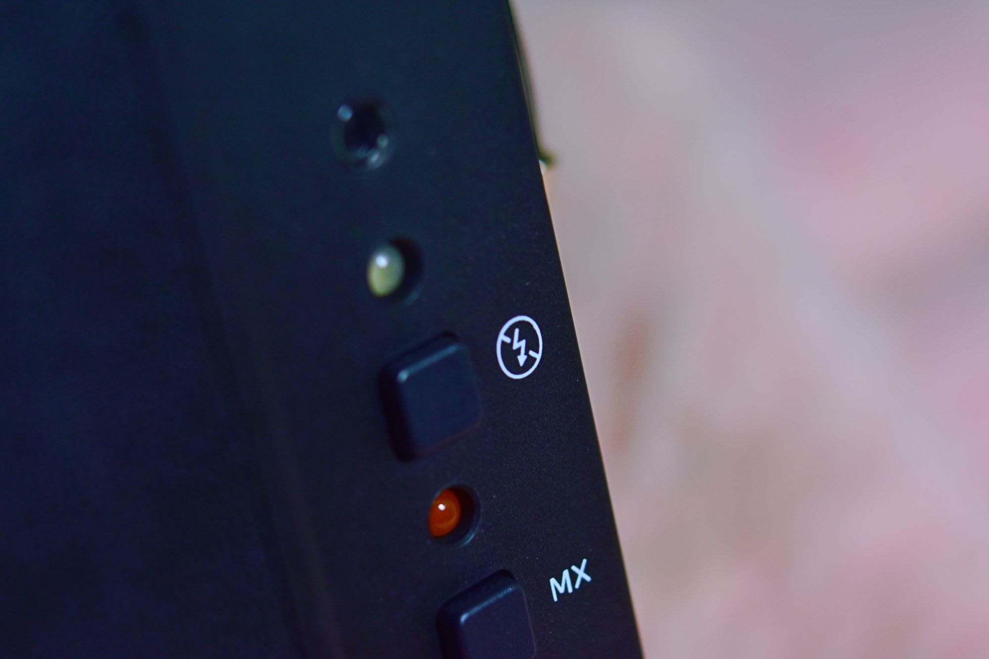Detailed close-up of buttons on a black electronic device with control indicators.