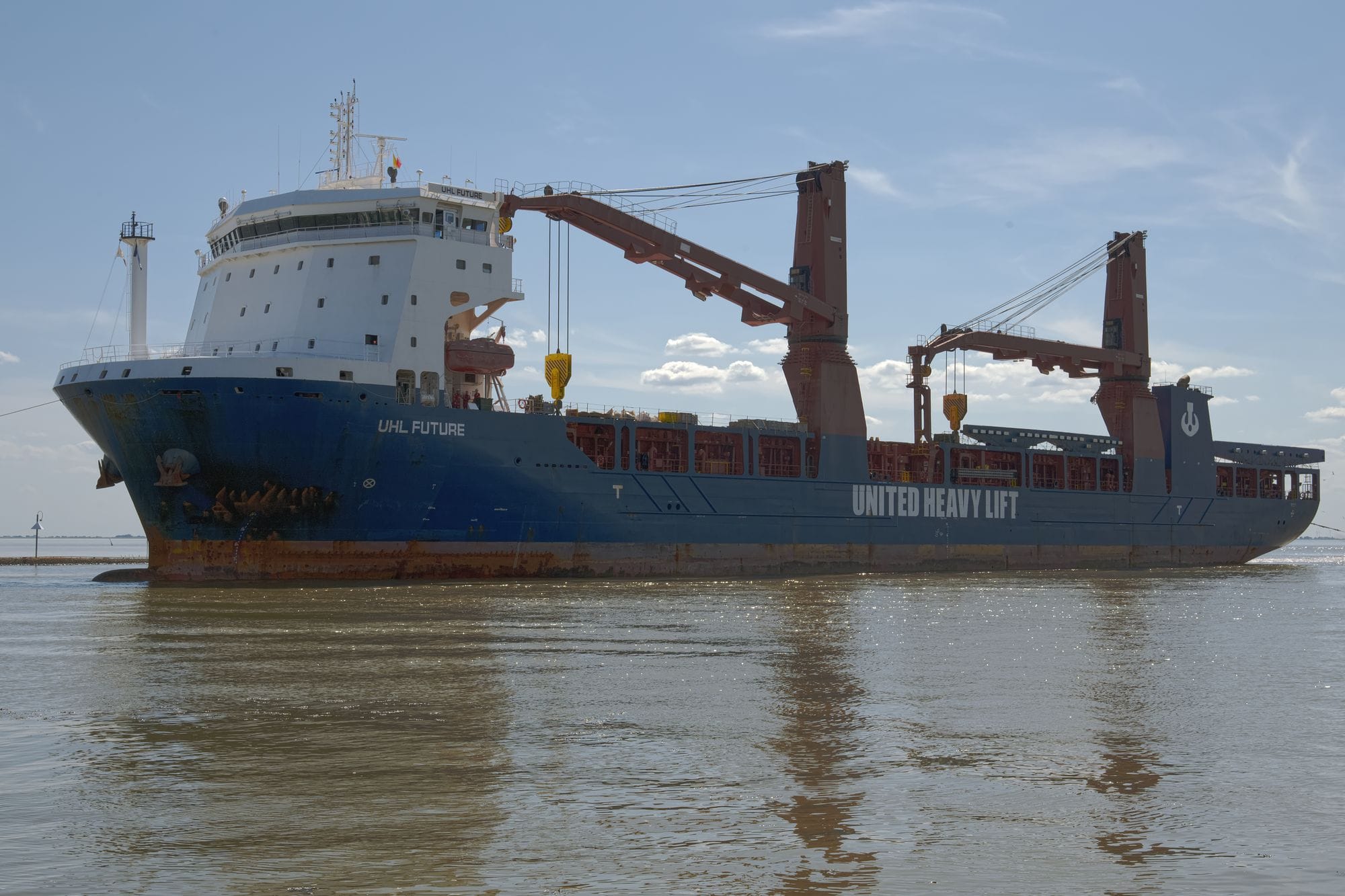 Cargo ship 'UHL Future' stationed at Emden harbor under a clear blue sky.