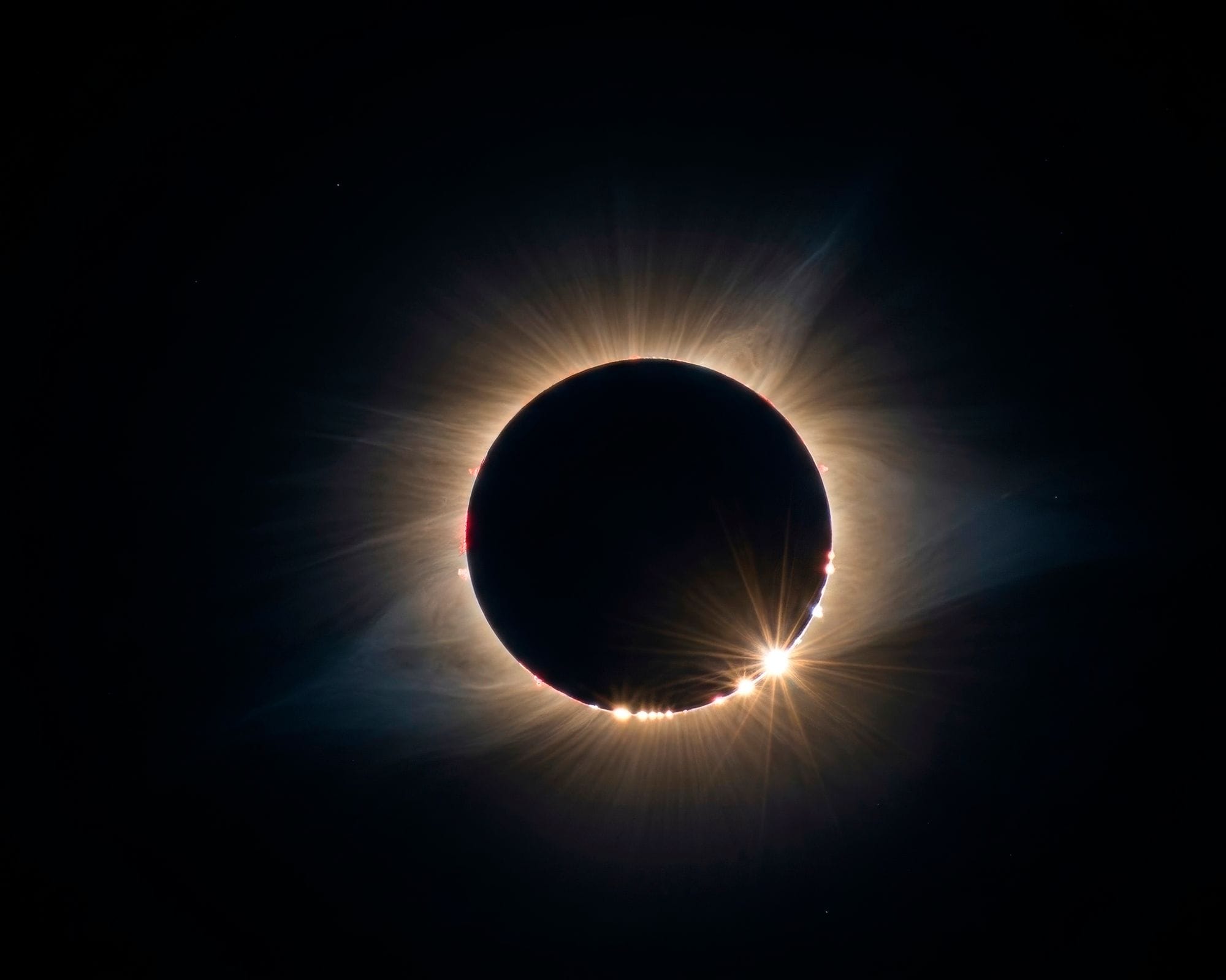 A breathtaking solar eclipse displaying the Baily's Beads effect and solar corona.