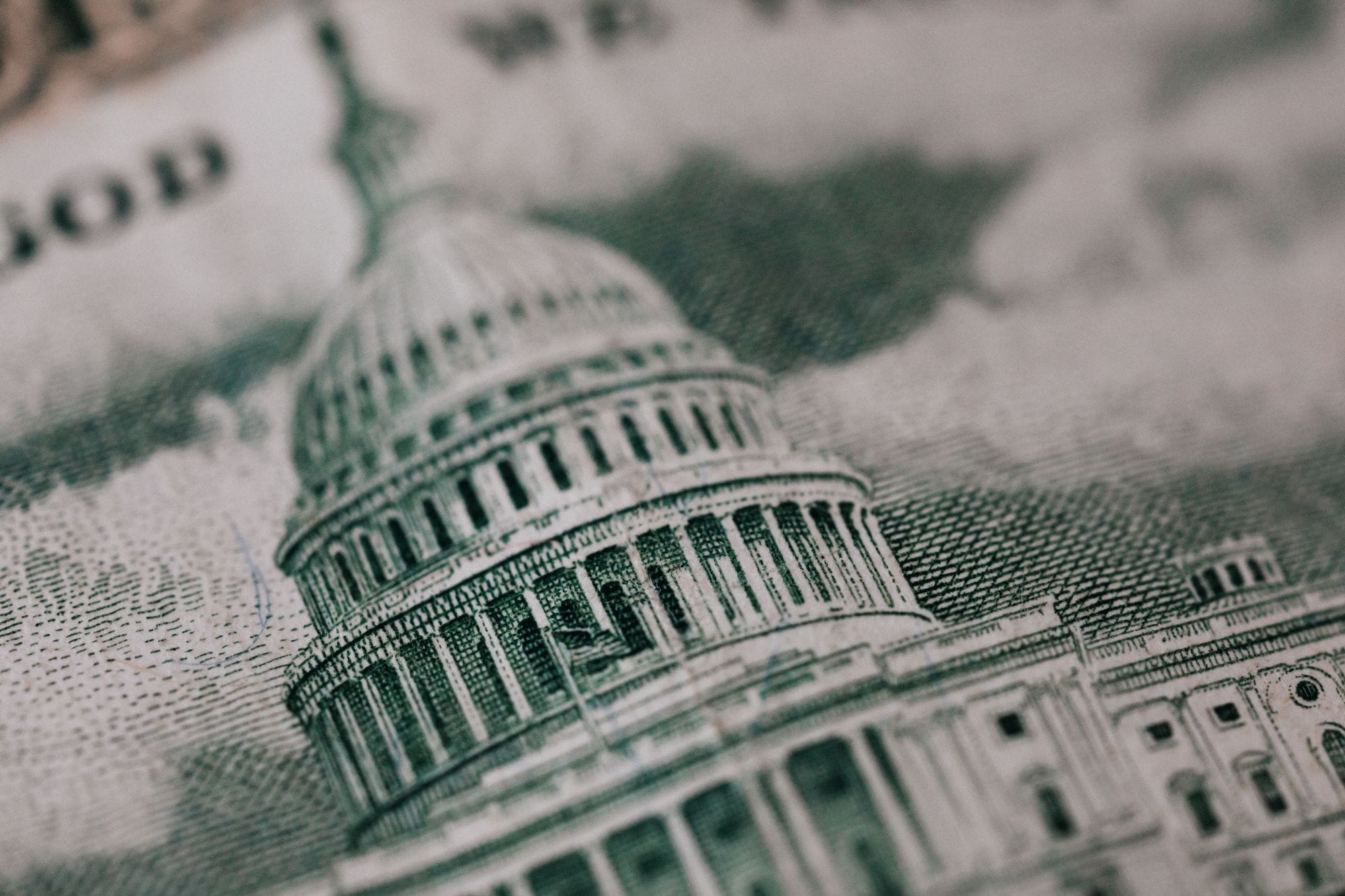 From above of photo of historic Capitol of USA Congress in neoclassical style with columns and dome represented on paper money