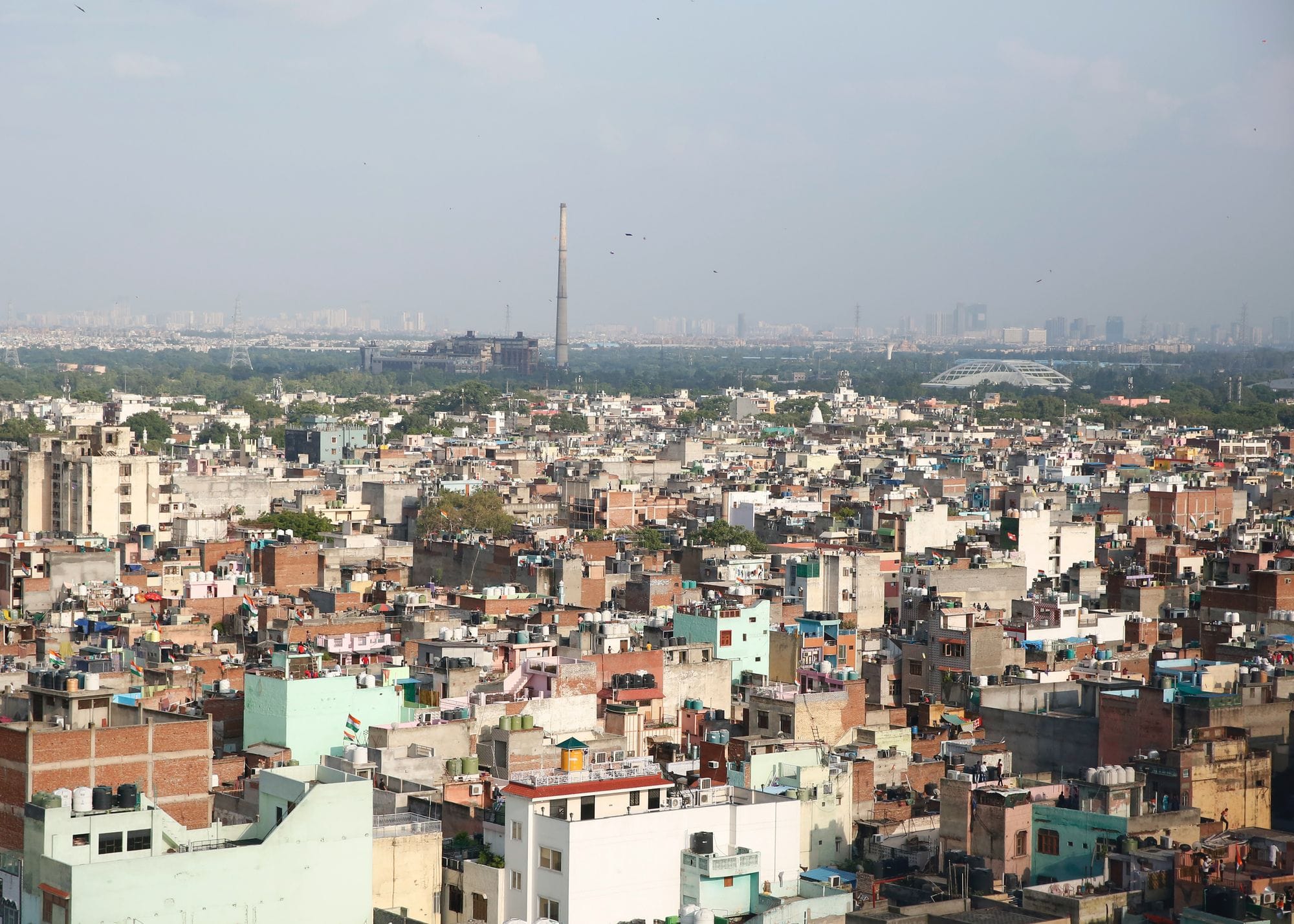 Drone shot capturing the dense urban sprawl of New Delhi, India.