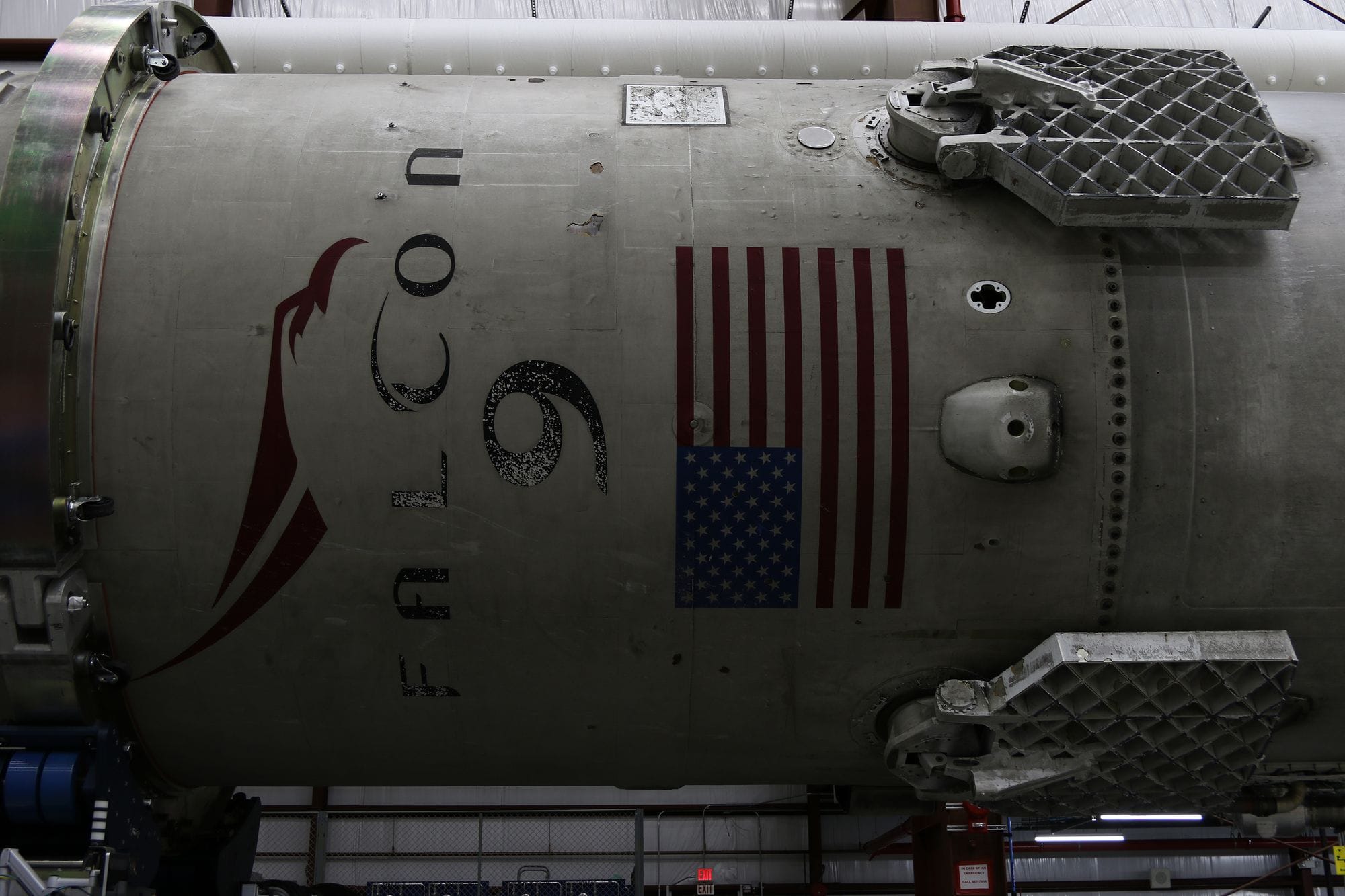 Fragment of modern spacecraft with printed flag of United States of America during assembly in rocket factory