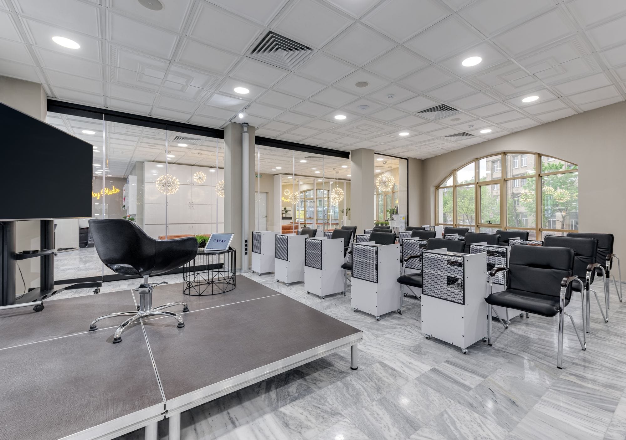 Spacious conference room with podium, chairs, and glass partitions featuring modern design elements.