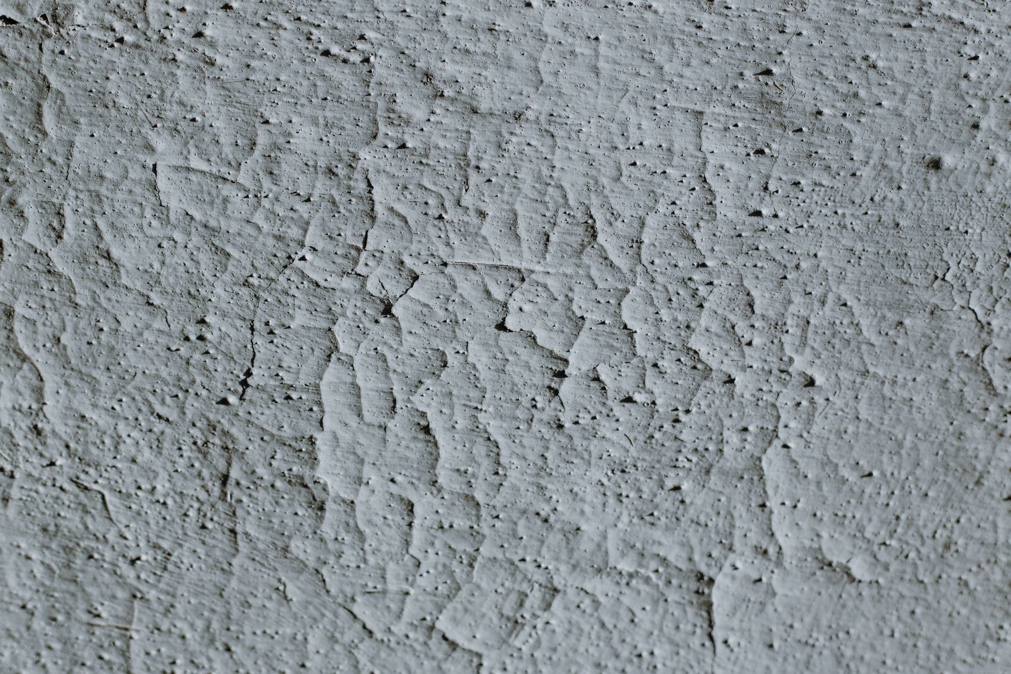 Detailed close-up of a textured concrete surface with visible cracks.