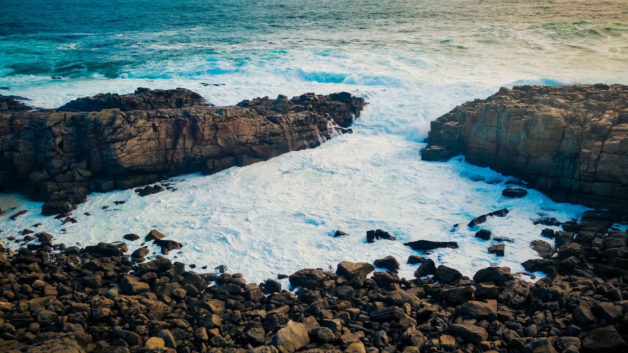 Dramatic waves crash against the rocky shoreline of Plettenberg Bay, South Africa.