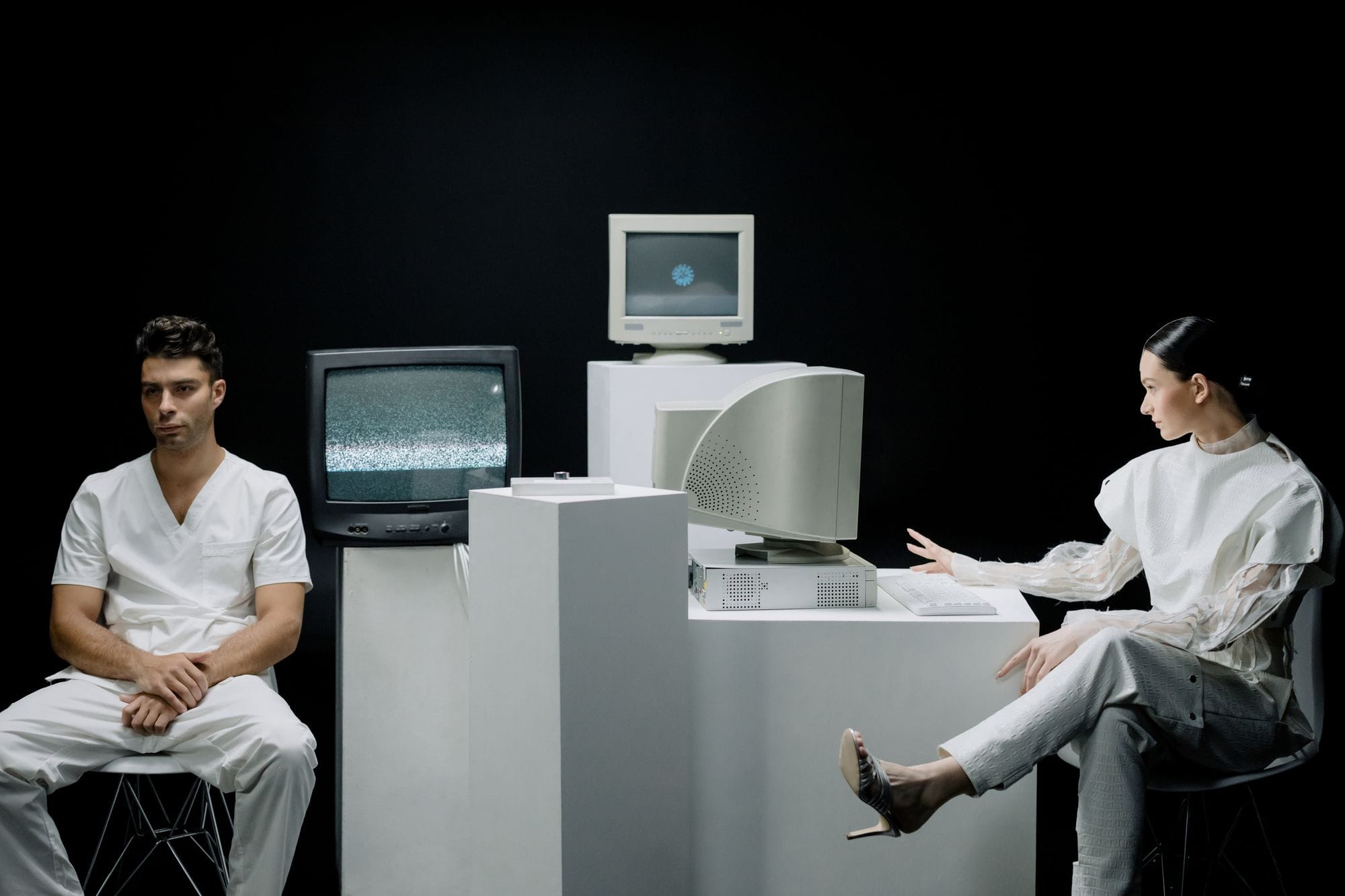 A modern depiction with vintage computers and individuals in a futuristic lab setting.