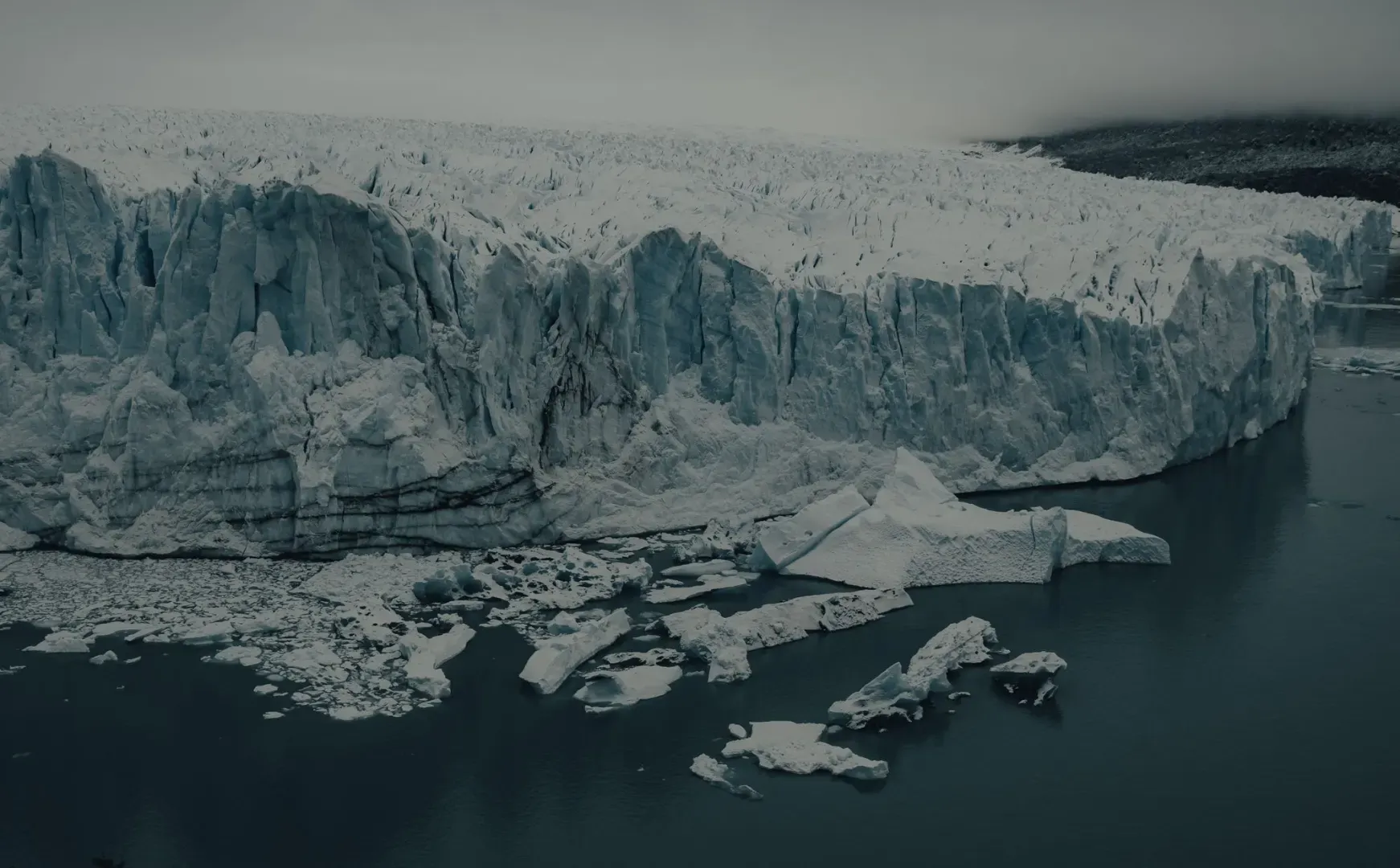 A stunning view of a massive iceberg amidst cold arctic waters, showcasing nature's grandeur.