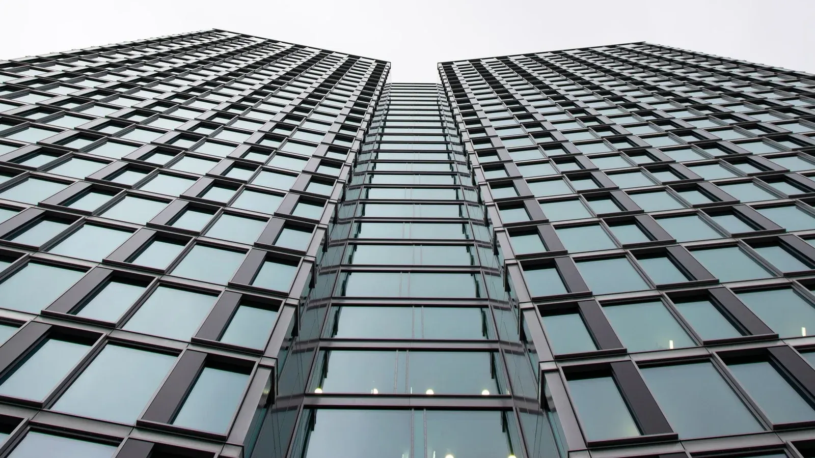 Low angle view of a modern office building with glass facade in Warsaw, Poland.