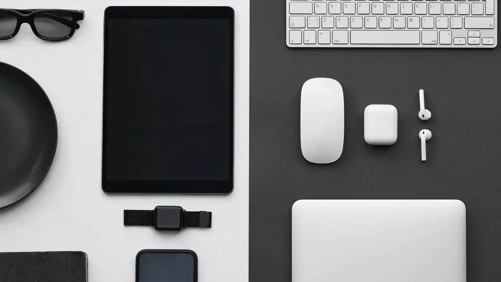 Stylish flatlay of modern tech gadgets including tablet, smartphone, smartwatch, and accessories.