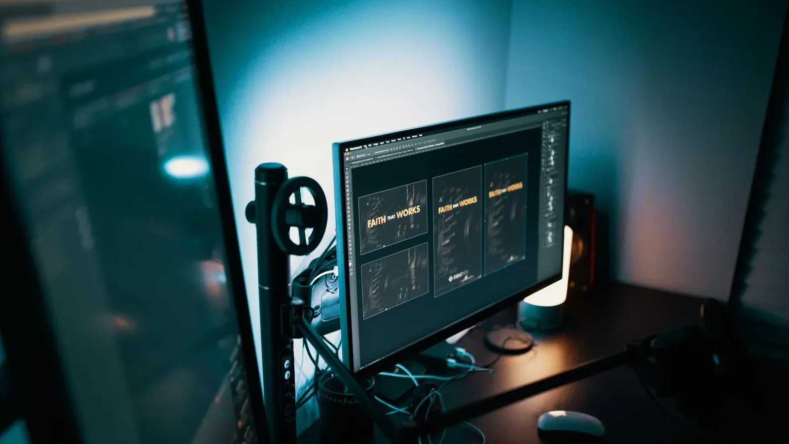 A stylish modern workspace with dual monitors displaying design software in a dimly lit room.