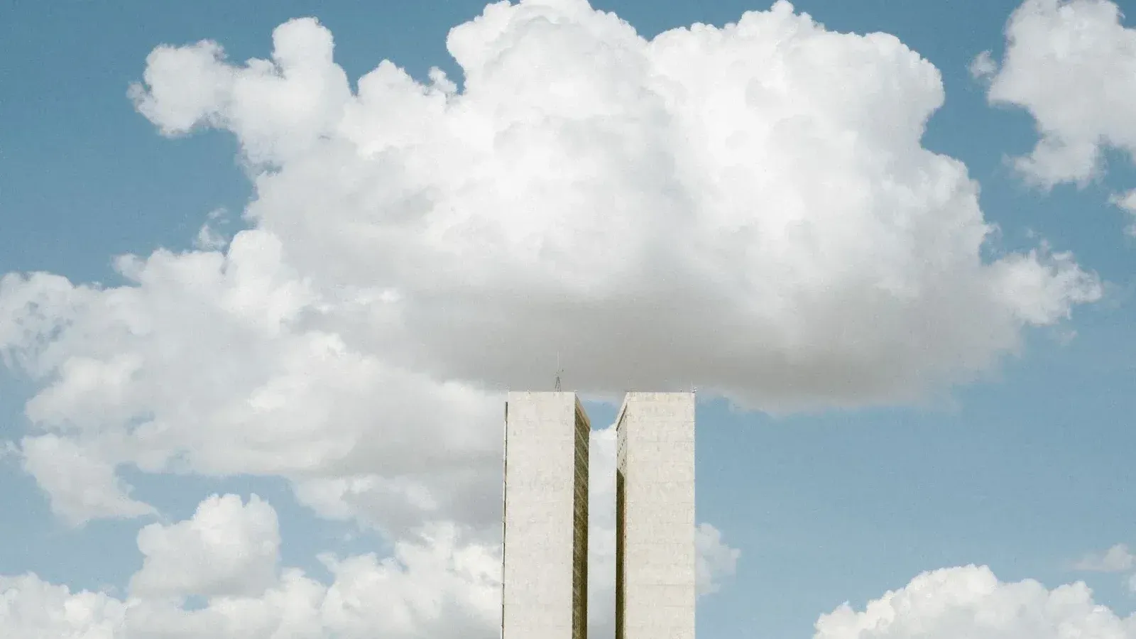 Vista del Congreso Nacional en Brasilia con impresionantes formaciones de nubes en el cielo.