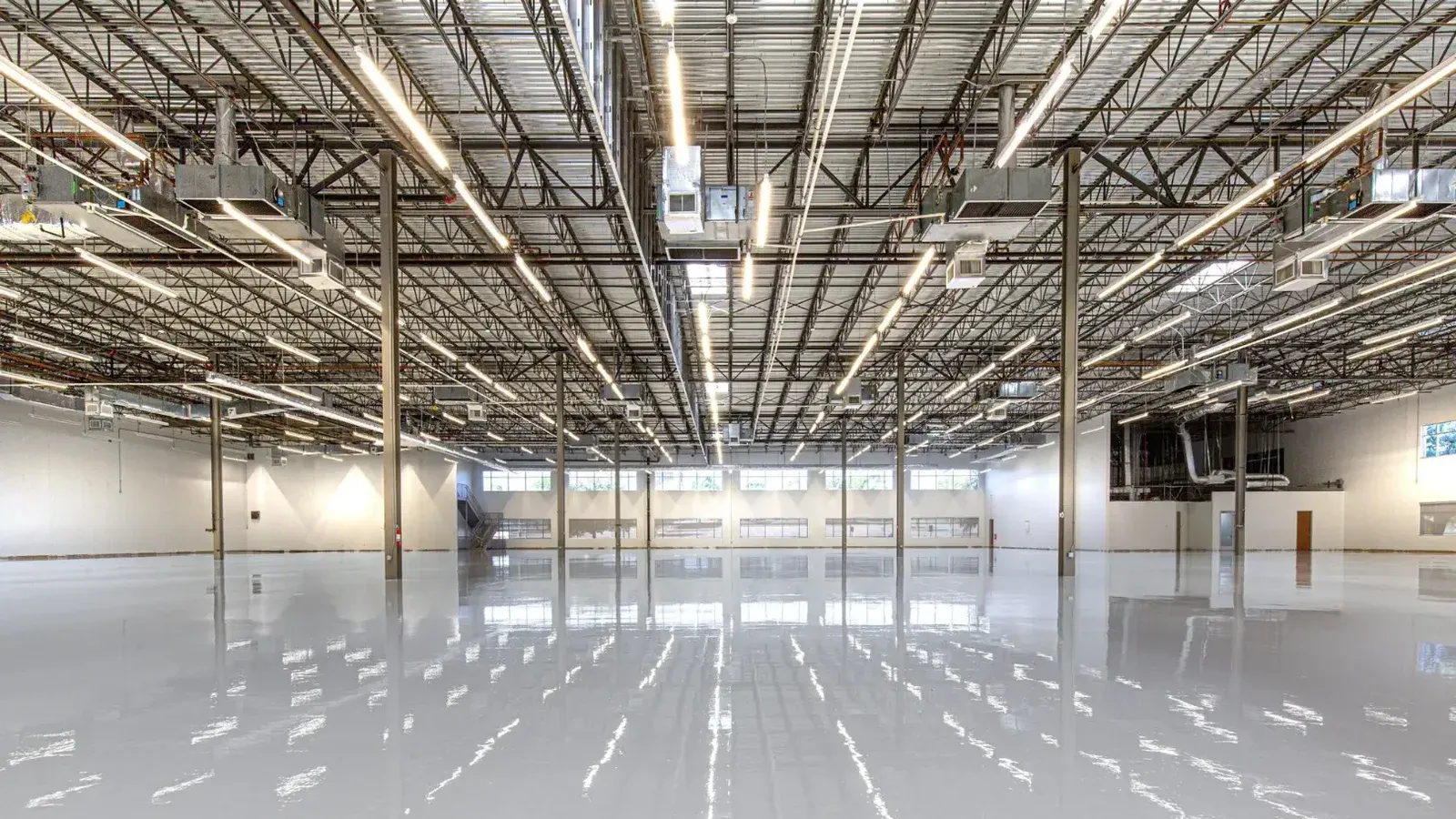 Spacious and polished industrial facility with glossy epoxy flooring in Houston, Texas.