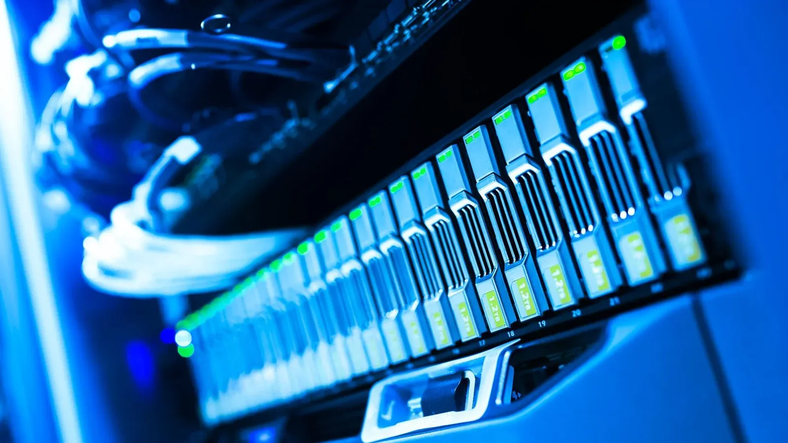 A detailed view of a blue lit computer server rack in a data center showcasing technology and hardware.