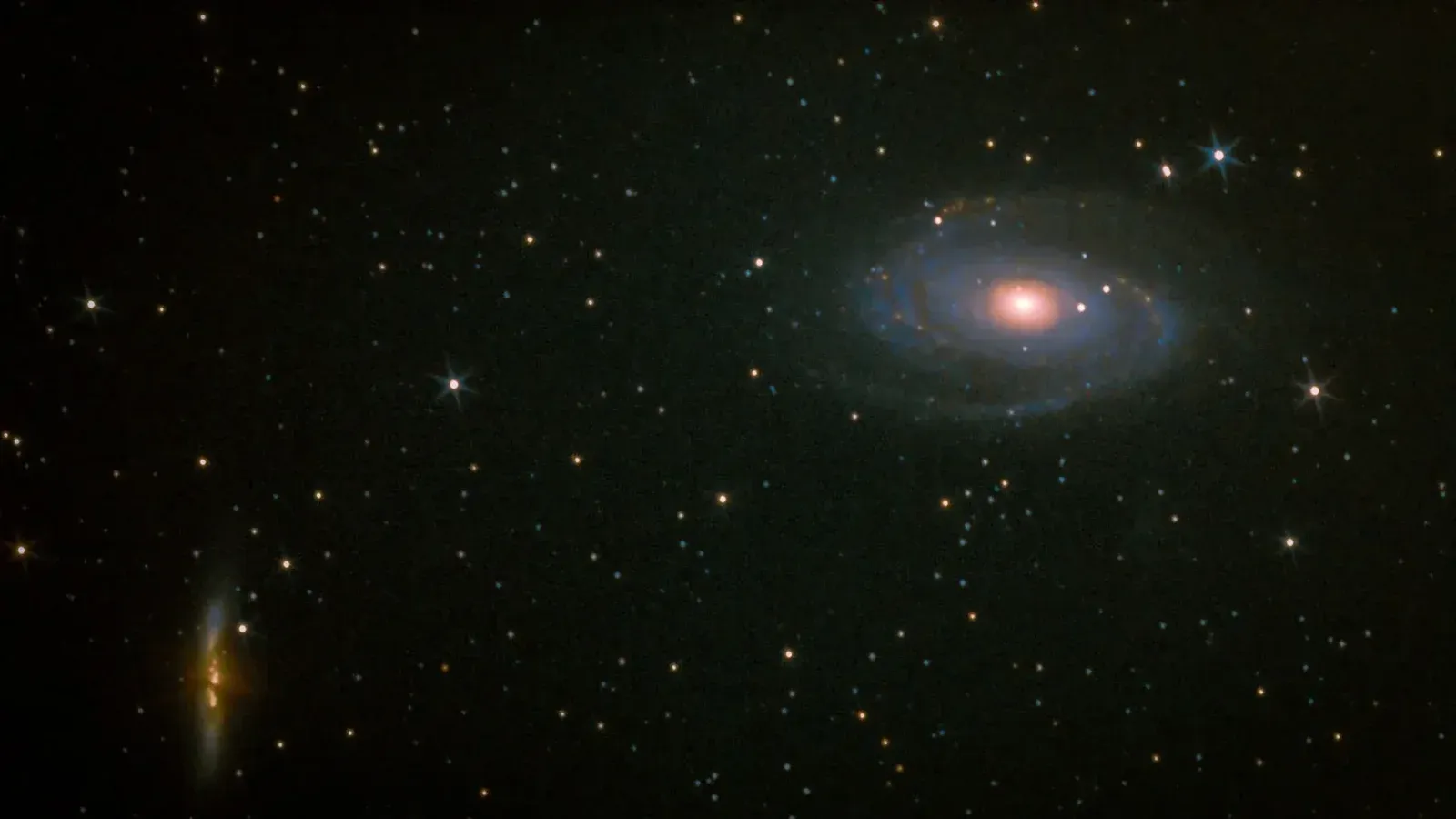 A captivating view of a spiral galaxy surrounded by thousands of stars in the night sky.