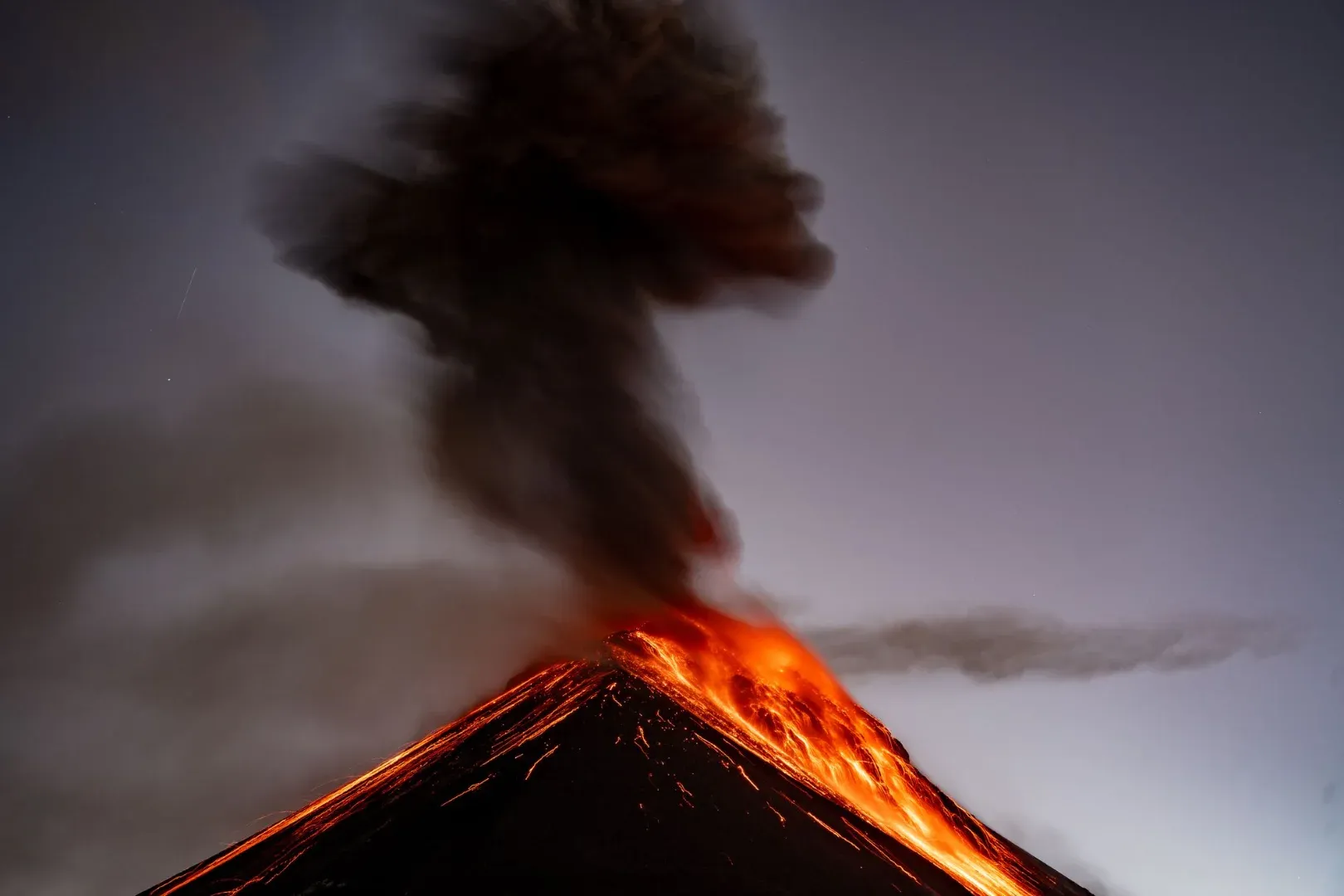 Dramatic capture of Volcano Fuego erupting in Chimaltenango, Guatemala, at dusk.