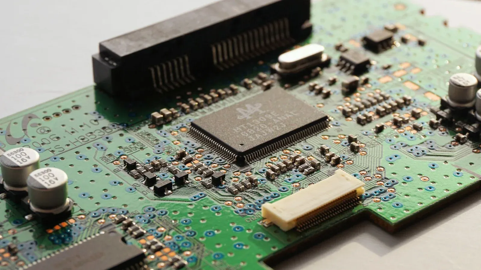 Detailed close-up photo of a circuit board highlighting microchip components and electronic circuits.