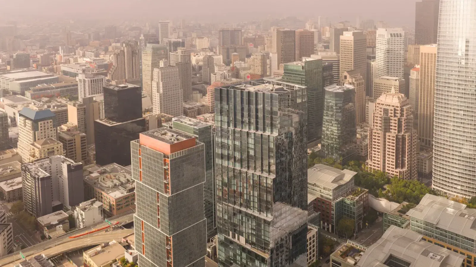 Stunning aerial view of San Francisco's modern skyline showcasing prominent skyscrapers on a foggy day.