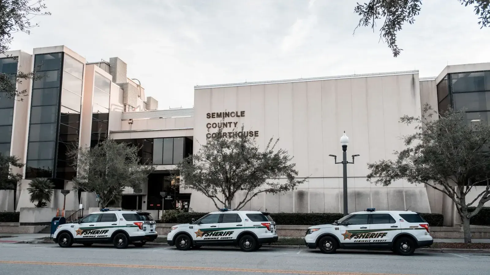 Sheriff vehicles parked in front of Seminole County Courthouse during the day.
