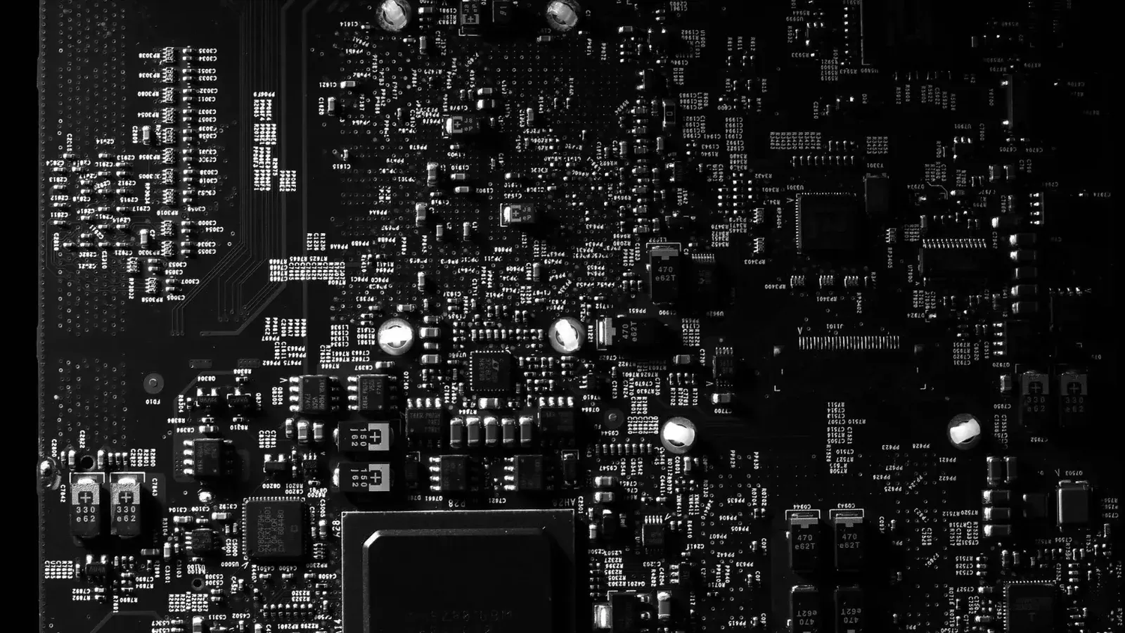 Detailed black and white photo of a circuit board showing intricate components, perfect for tech projects.