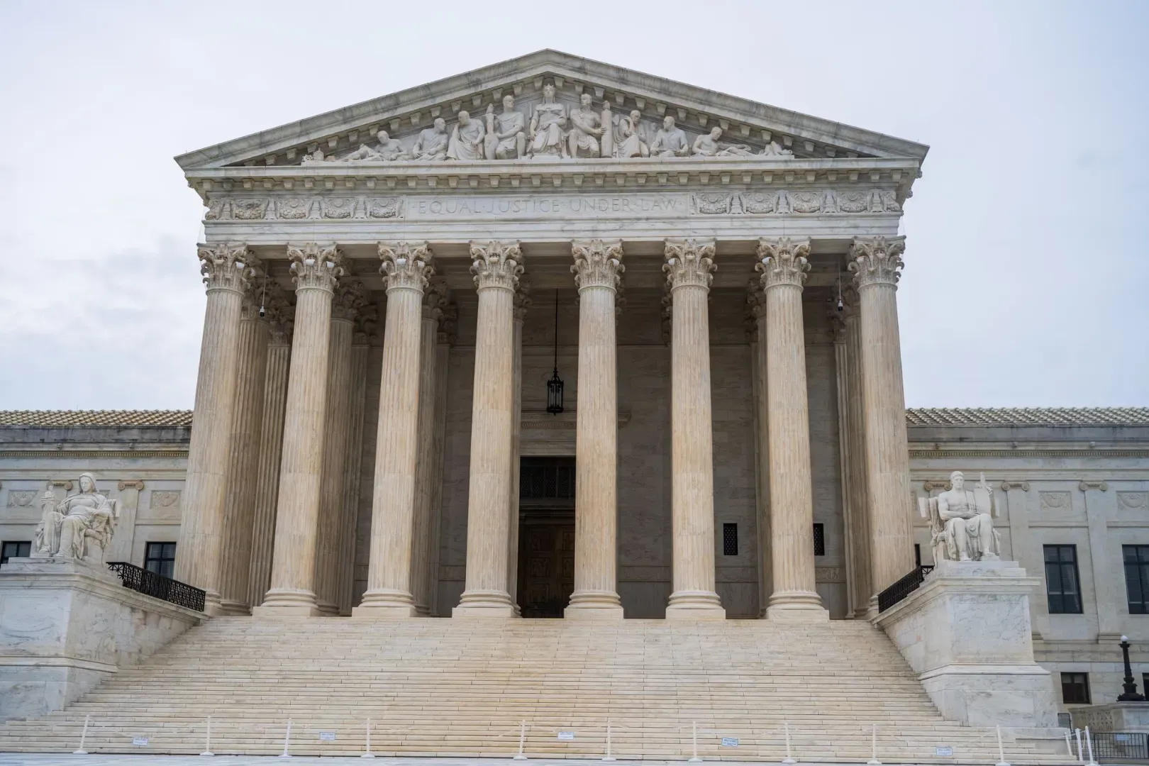 Front view of the iconic US Supreme Court building showcasing its grand columns and classic architecture.