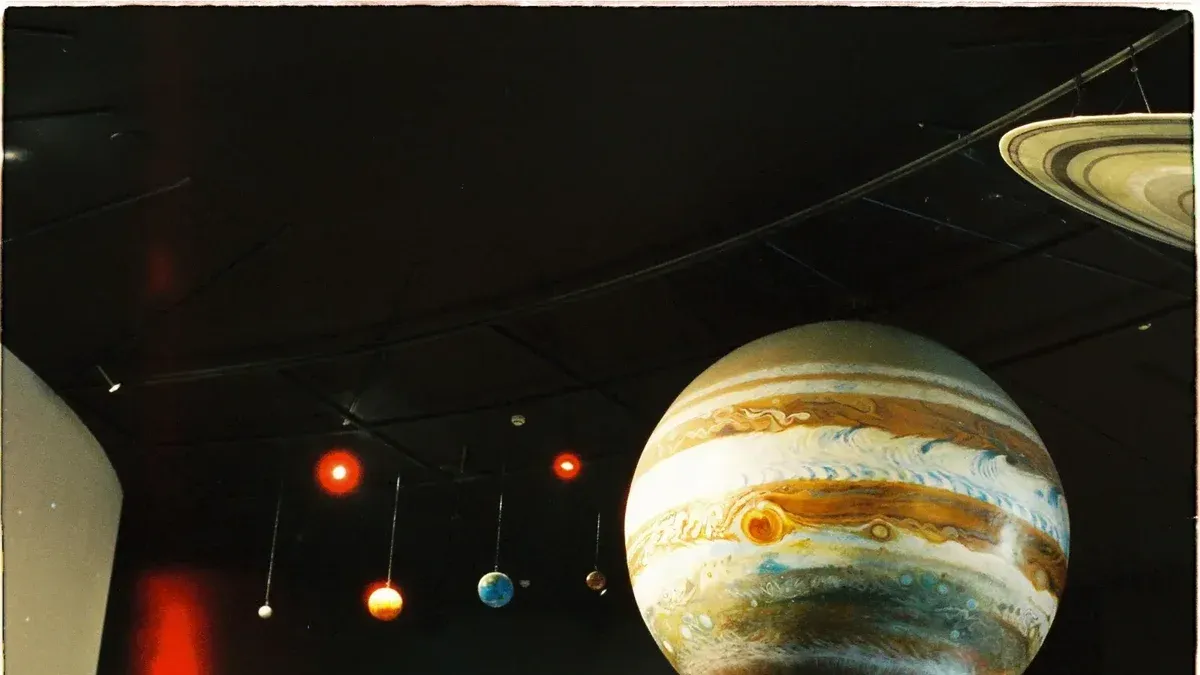 A model of the solar system with planets is on display at a science museum.