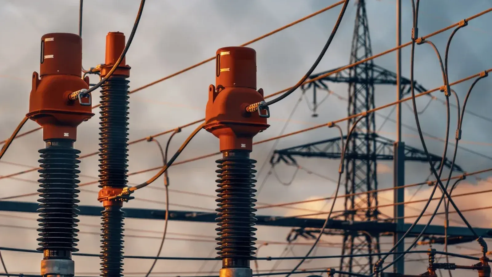 Detailed view of power transformers and lines against a sunset sky in Austria.