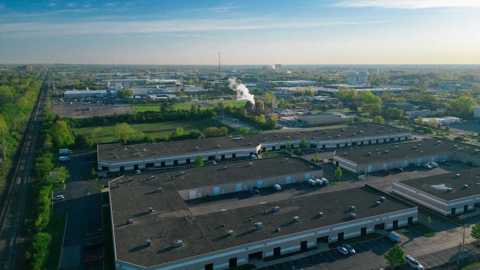 Expansive aerial view of an industrial area showcasing buildings, roads, and green spaces.