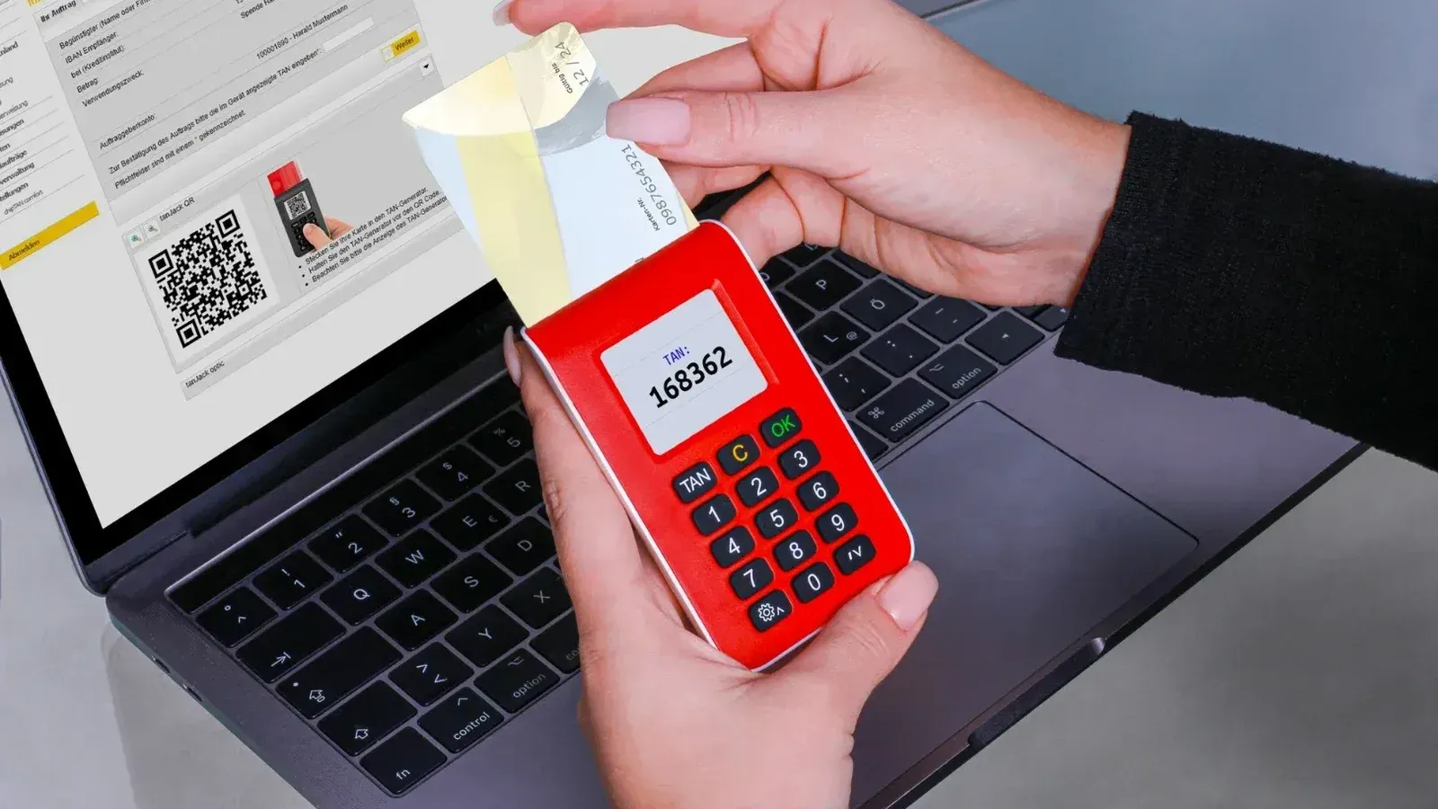 Woman using TAN generator for secure online payment on laptop, enhancing cybersecurity.