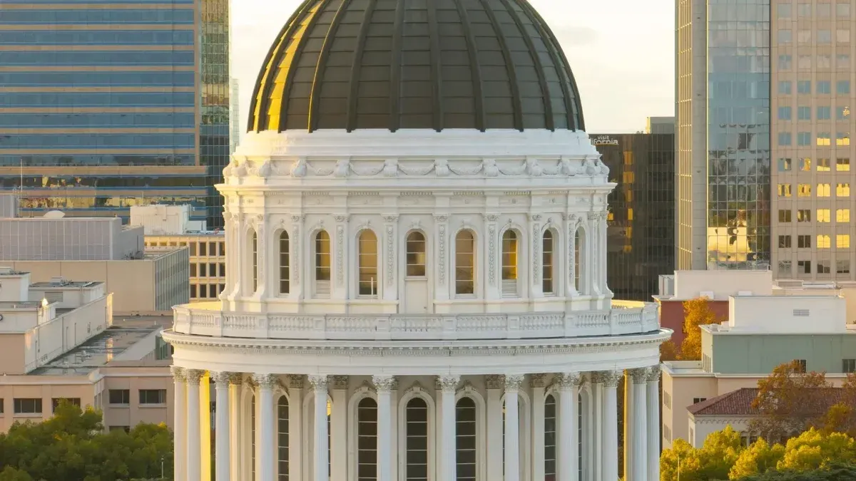 Majestic view of the California State Capitol Dome in Sacramento during sunset with clear skies.