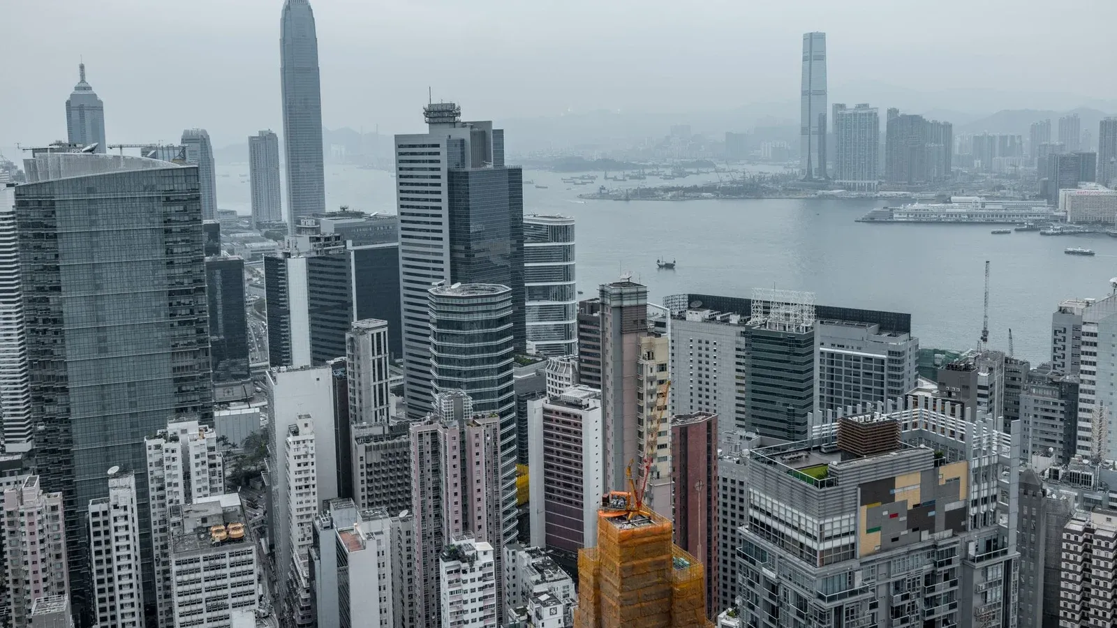 Elevated view of Hong Kong's modern skyscrapers and Victoria Harbor.