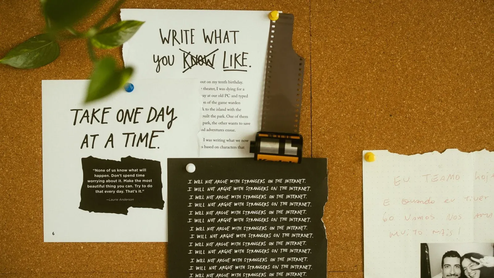 A corkboard with motivational quotes, notes, and film negatives, fostering creativity and reflection.
