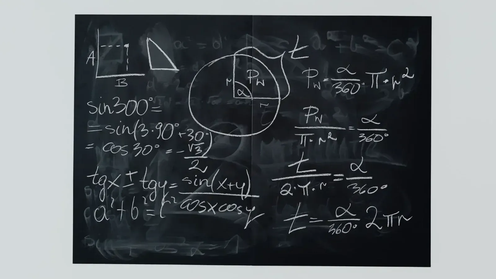 Detailed view of mathematical equations and diagrams on a blackboard.
