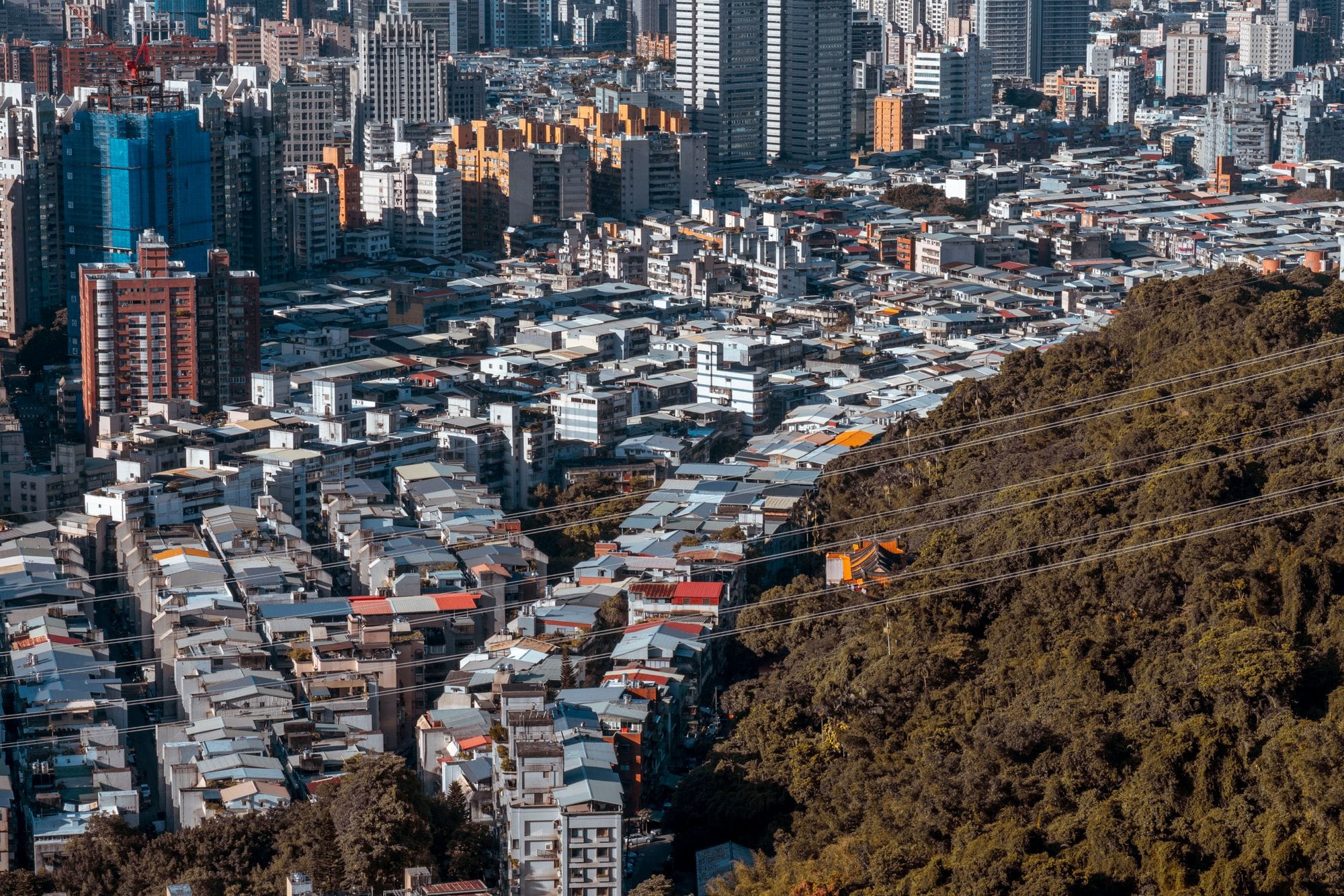 Aerial view of a densely populated residential area with skyscrapers in Taipei, Taiwan.