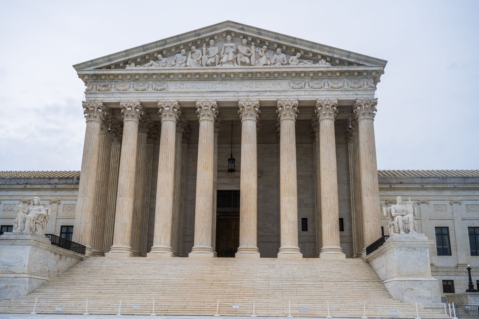 Front view of the iconic US Supreme Court building showcasing its grand columns and classic architecture.