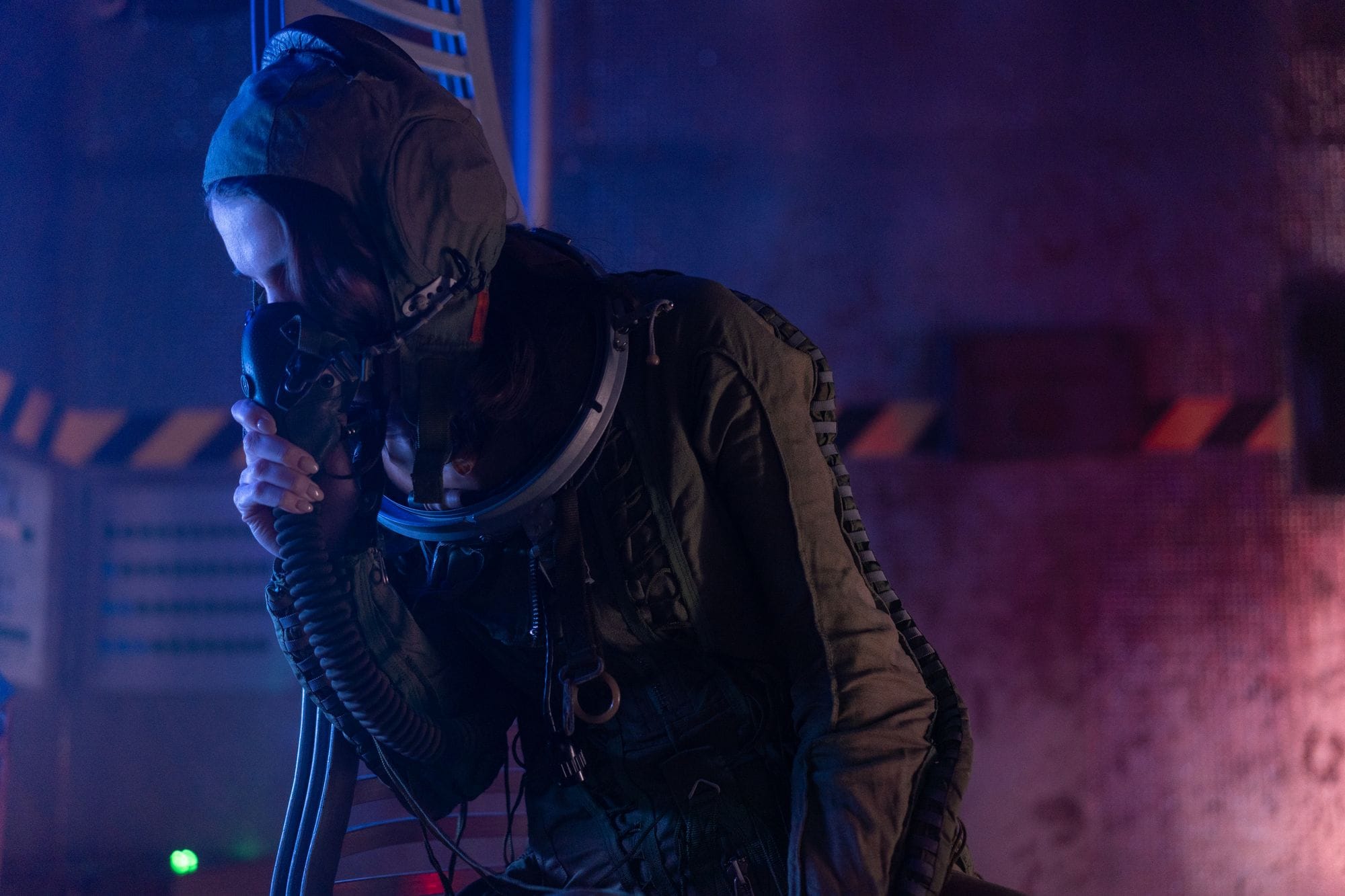 A weary astronaut in a spacesuit rests inside a futuristic spacecraft, conveying fatigue and exploration.