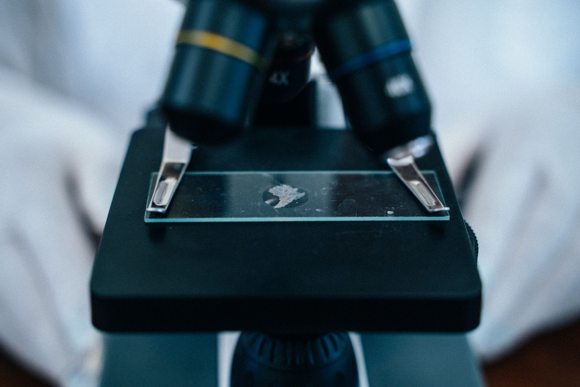 Detailed shot of a microscope eyepiece with a slide, ideal for scientific and research themes.
